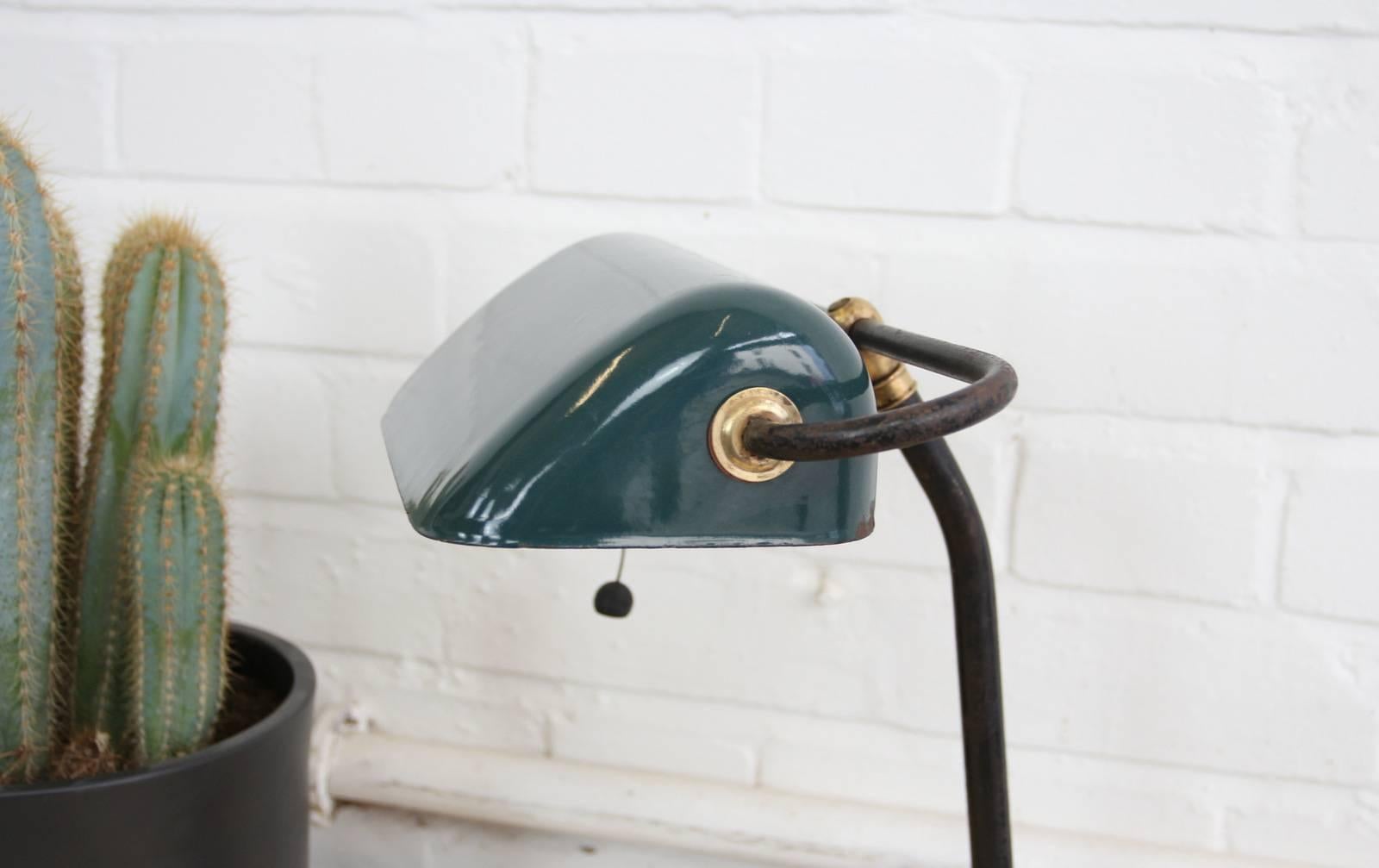 Bankers desk lamp by Gebruder Jacob, circa 1920s

- Cast iron base
- Vitreous green enamel shade
- Original pull cord on or off switch
- Takes E27 fitting bulbs
- German, circa 1920s
- Measures: 40cm tall x 31cm wide x 21cm deep

Condition