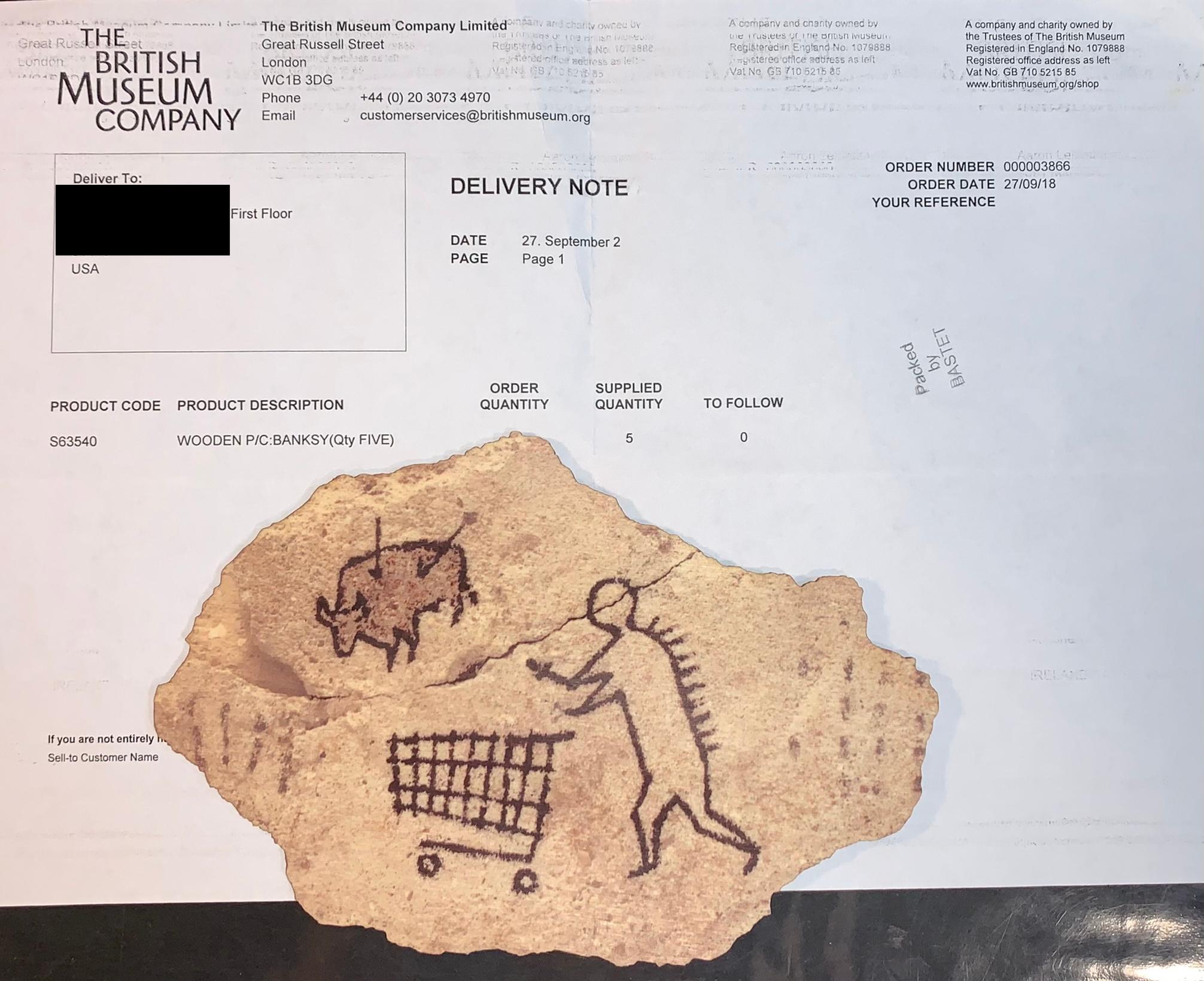 A wooden replica of Banksy's "Peckham Rock" wall art.

"Banksy's 'Peckham Rock' is a piece of concrete showing a supposed prehistoric figure pushing a shopping trolley. This was placed in The British Museum in 2005, accompanied by an authentic