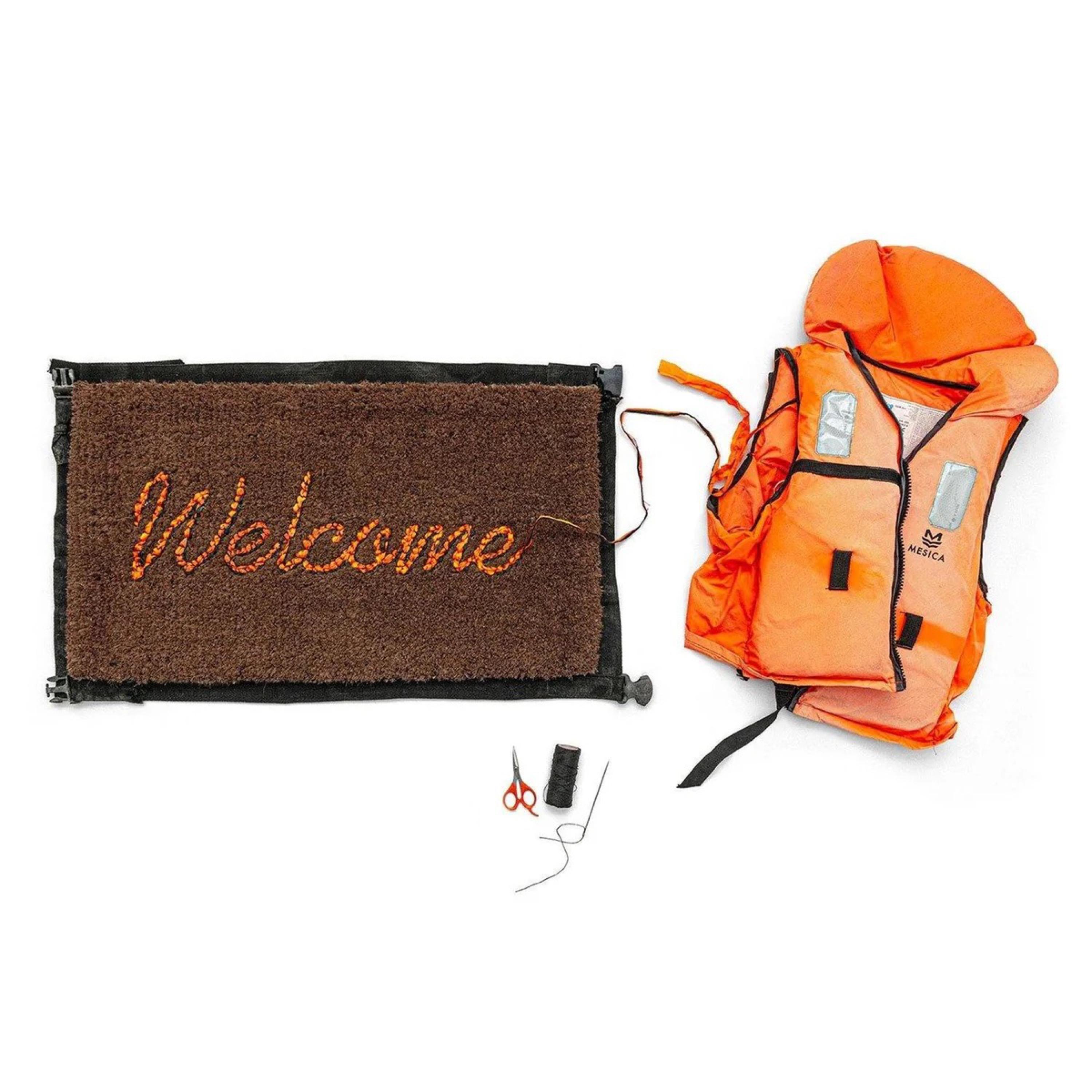 Banksy, Love Welcomes, Welcome Mat, 2019

Life vest fabric on a fibre doormat

43.2 × 61 × 3.2 cm (17 × 24 × 1 1/4 in)

New, as issued, comes in the original Love Welcomes packaging and gallery-issued Certificate of Authenticity.

Banksy Welcome