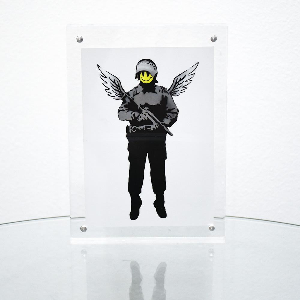 Super cool and rare Banksy Angel Cop Showcard.
Also known as Flying Copper.
Banksy also released a print with a similar image (upper half). The image on this Showcard features Banksy stencil and spraypaint original artwork from 2005.
From the Banksy