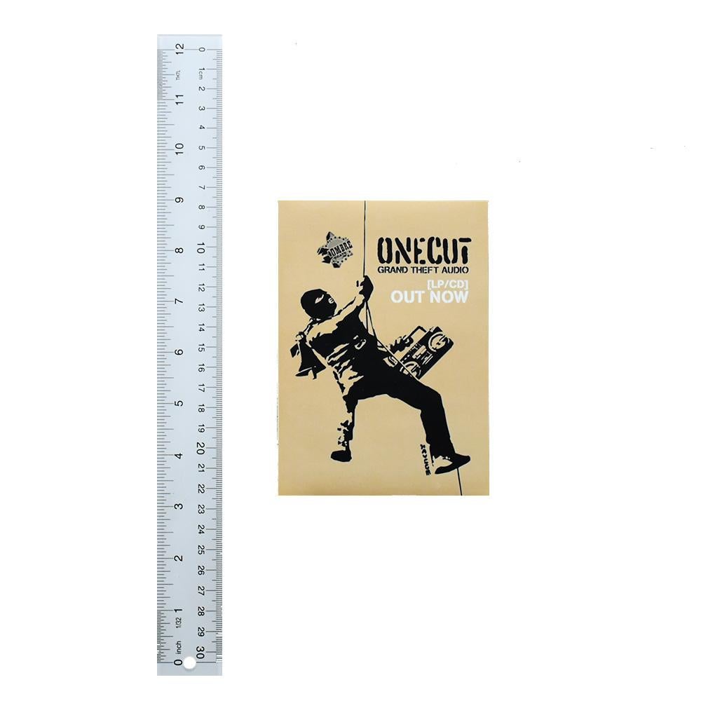Extremely rare Banksy One Cut Grand Theft Audio Sticker.
Sticker was made for the release of the album by the band One Cut.
Features Banksy artwork of masked man.
Has Banksy stencil signature printed on side with image.
Released in 2000.
Comes with