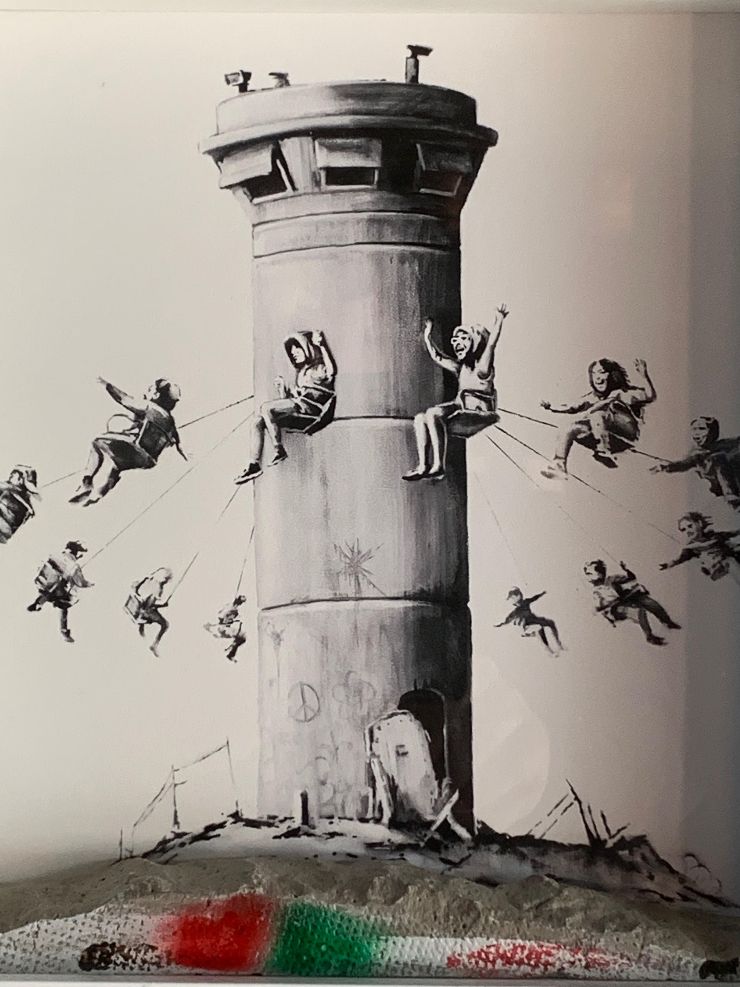 Banksy The Walled Off Hotel Box Set Banksy (British, b.1974)

Banksy (British, b.1974) The Walled Off Hotel Box Set,  Depicts the watch tower as fairground swing contained within the frame is a concrete base from the separation barrier in the West