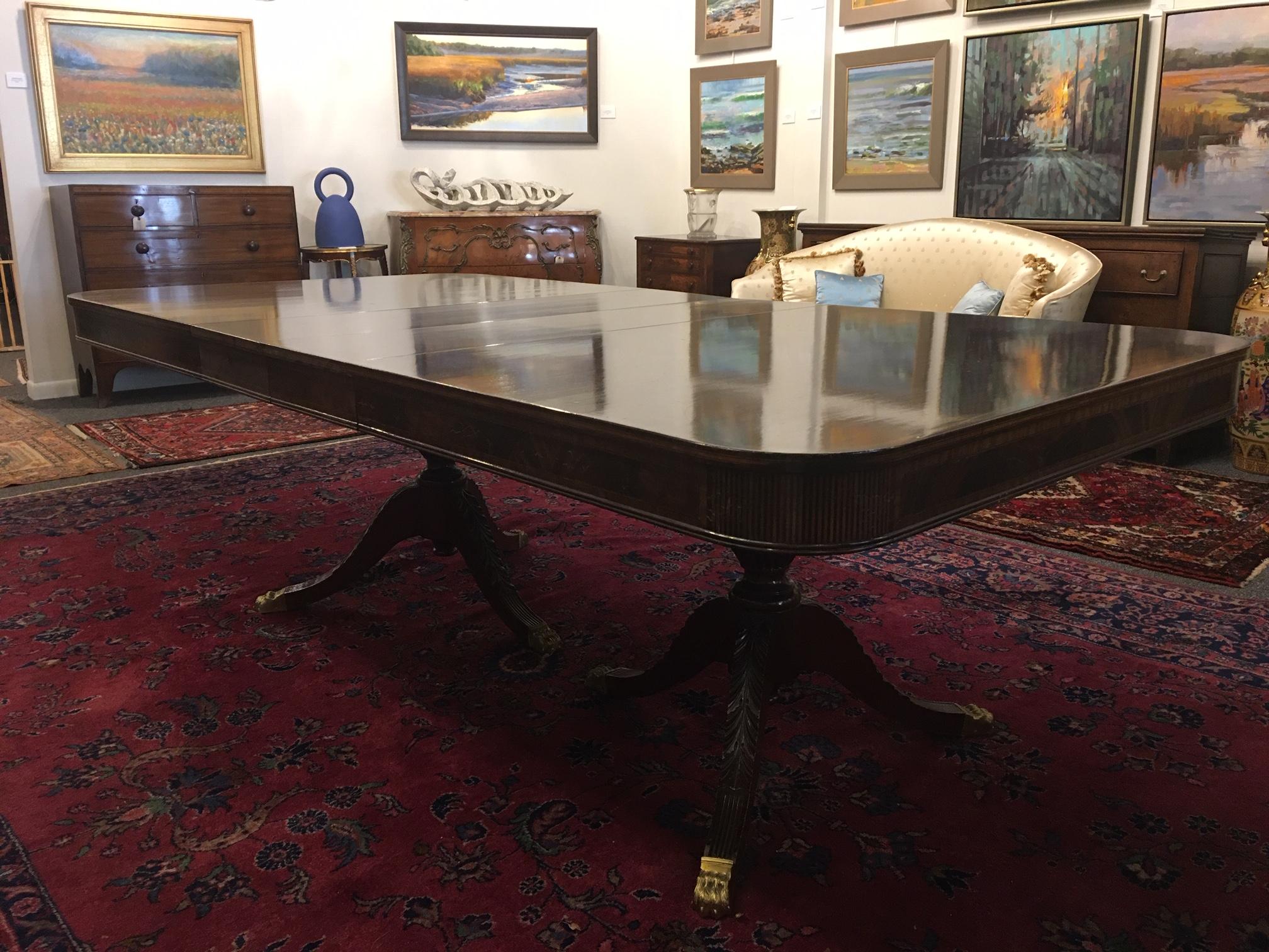 Banquet English mahogany dining room table with two pedestals and an extra support leg in the center, late 19th century. 48” W x 144” L (6 leaves each 12” W). Length of table without any leaves is 72