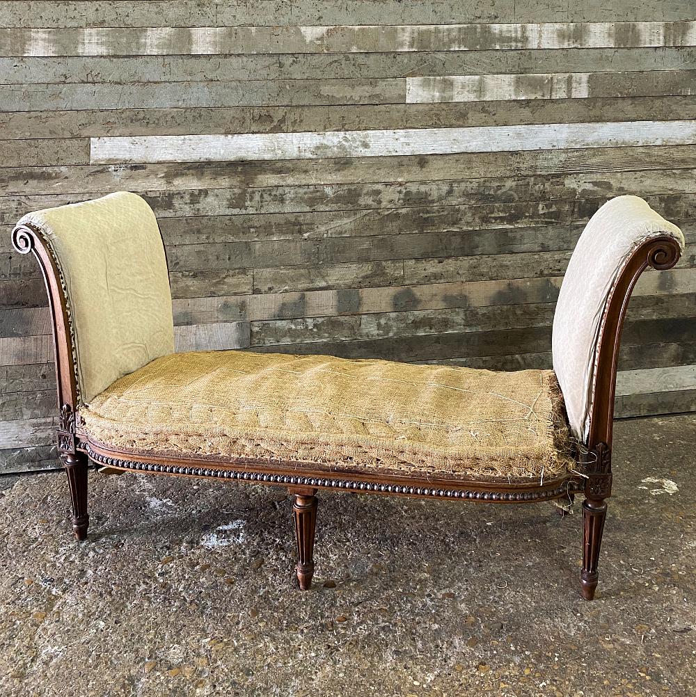 19th century French walnut Louis XVI banquette has unusually high sides, all designed to be upholstered, nestled with a frame hand-sculpted from luxurious walnut and carved with rosettes, egg and dart molding, and shaped in a graceful design