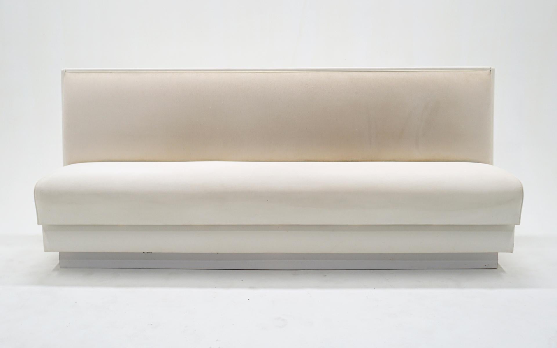 Custom made, super high quality banquette / bench / sofa.  Off white upholstery seat and seat back with leather-like vinyl sides and finished back.  This was custom made for a space and used very little.  No stains, holes or tears.  Minor pilling,