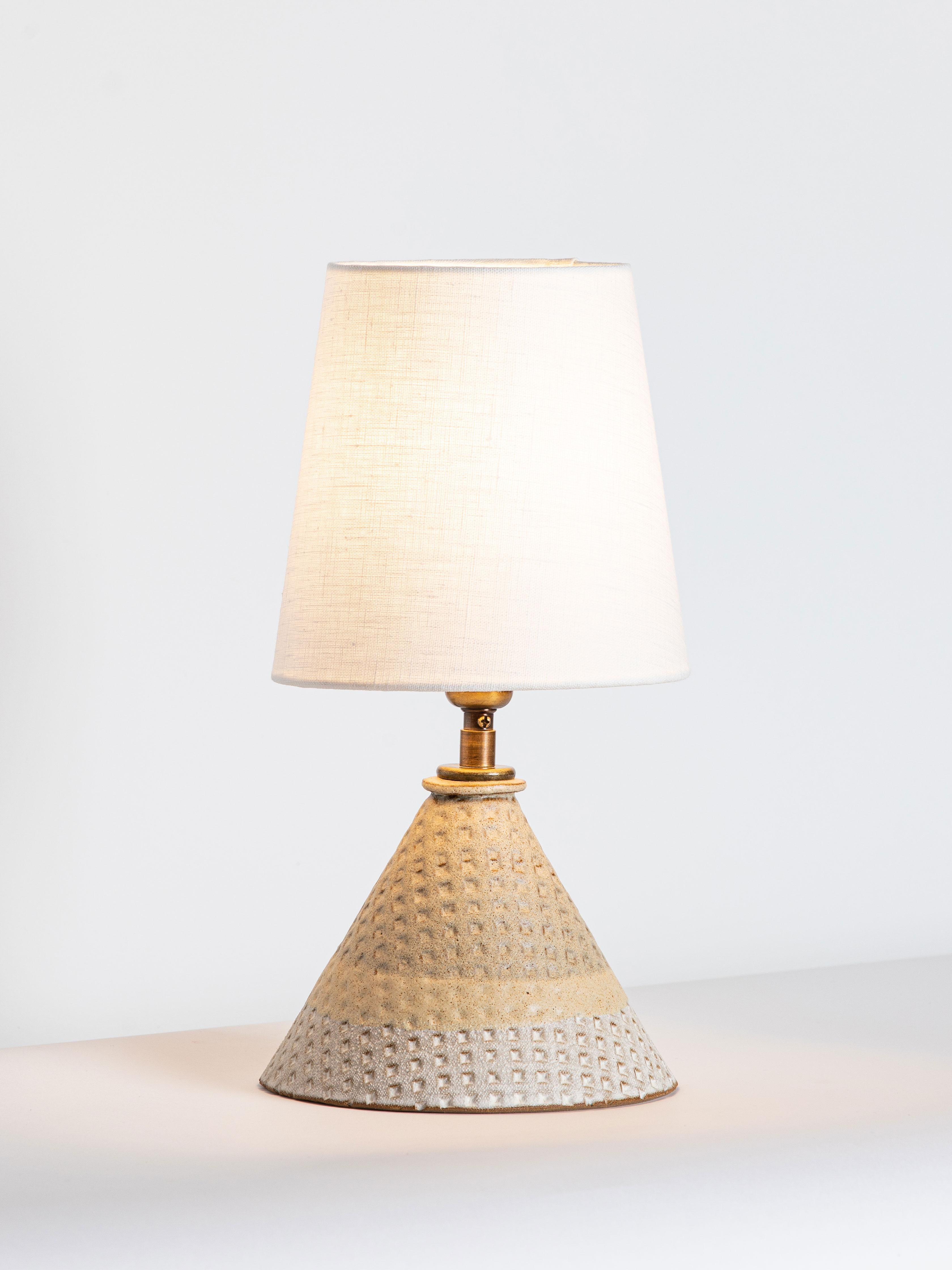 Our stoneware Bantam Lamp is handcrafted using slab-construction techniques. The lamp’s pattern is created by rolling the surface with textured rolling pins and rods.

FINISH

- Ochre & chalk dipped glaze 
- Antique brass fittings
- Twisted