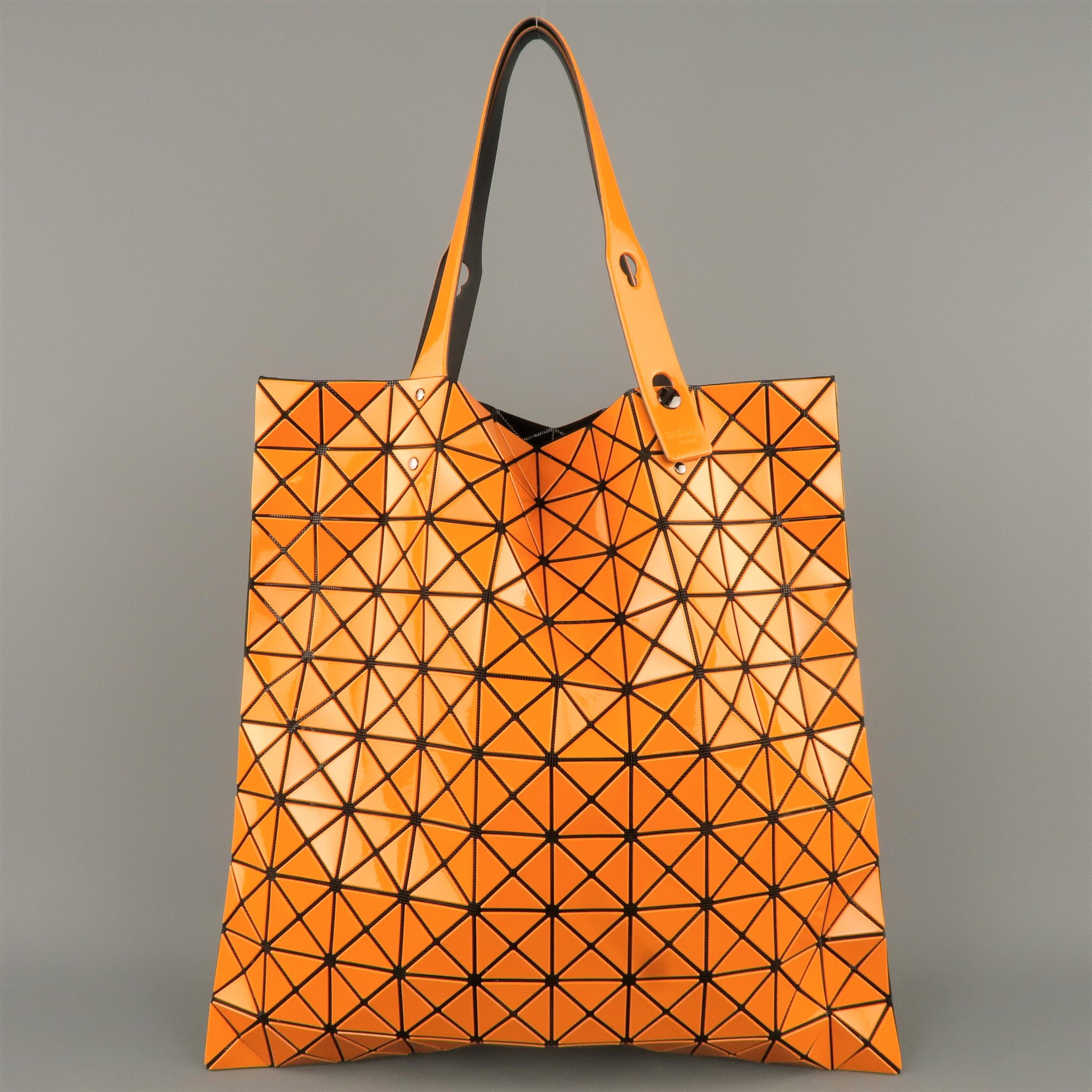 BAO BAO by ISSEY MIYAKE Lucent tote bag comes in black mesh with geometric orange PVC overlay, adjustable straps, and internal pocket. Never worn.
 
New without Tags.
 
Size: 15.5 x 15.5 in.
Drop: 8 in.