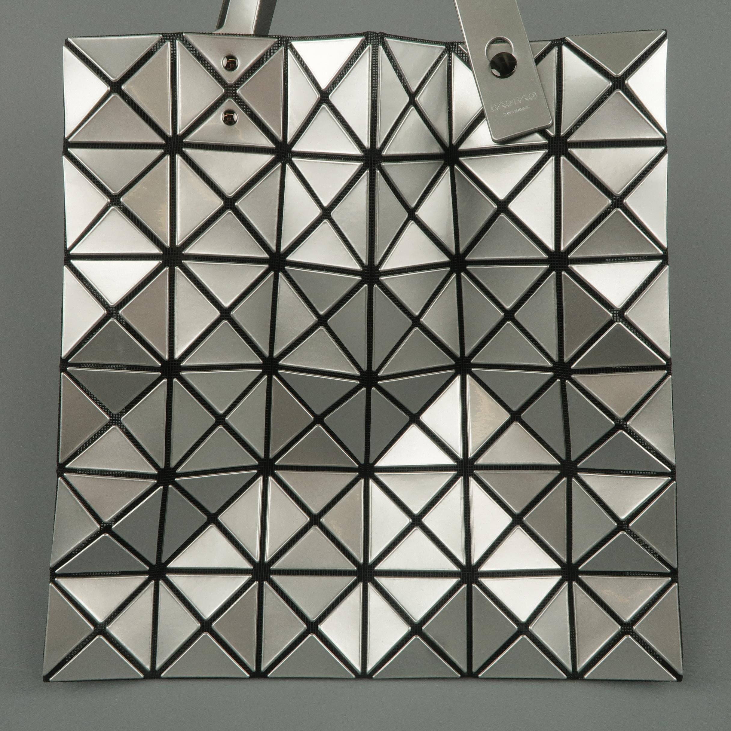 BAO BAO by ISSEY MIYAKE Lucent tote bag comes in black mesh with geometric silver PVC overlay, adjustable straps, and internal pocket. Never worn.
 
New without Tags.
 
13.5 x 13.5 in.
Drop: 7 in.