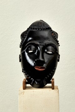 Baoulé portrait mask, carved wood, lacquer and pigments, circa 1940, Africa.