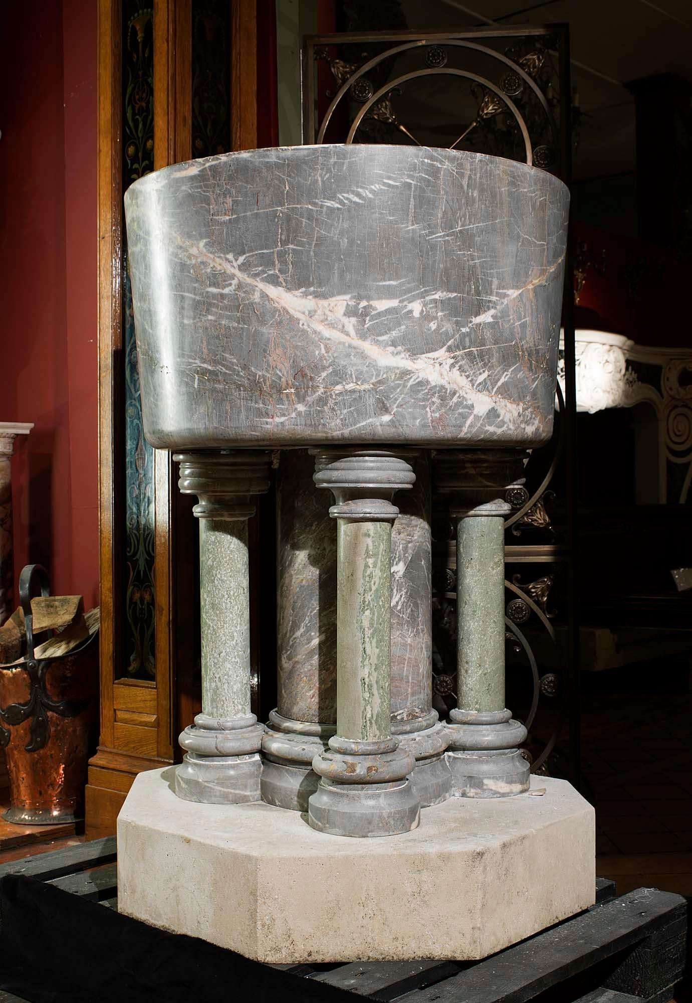 An impressive and large baptismal font entirely carved from Ashburton Marble. This is a soft grey and blush pink, lightly veined marble with evidence of fossil remains of creatures, principally corals, crinoids and brachiopods, that lived in the
