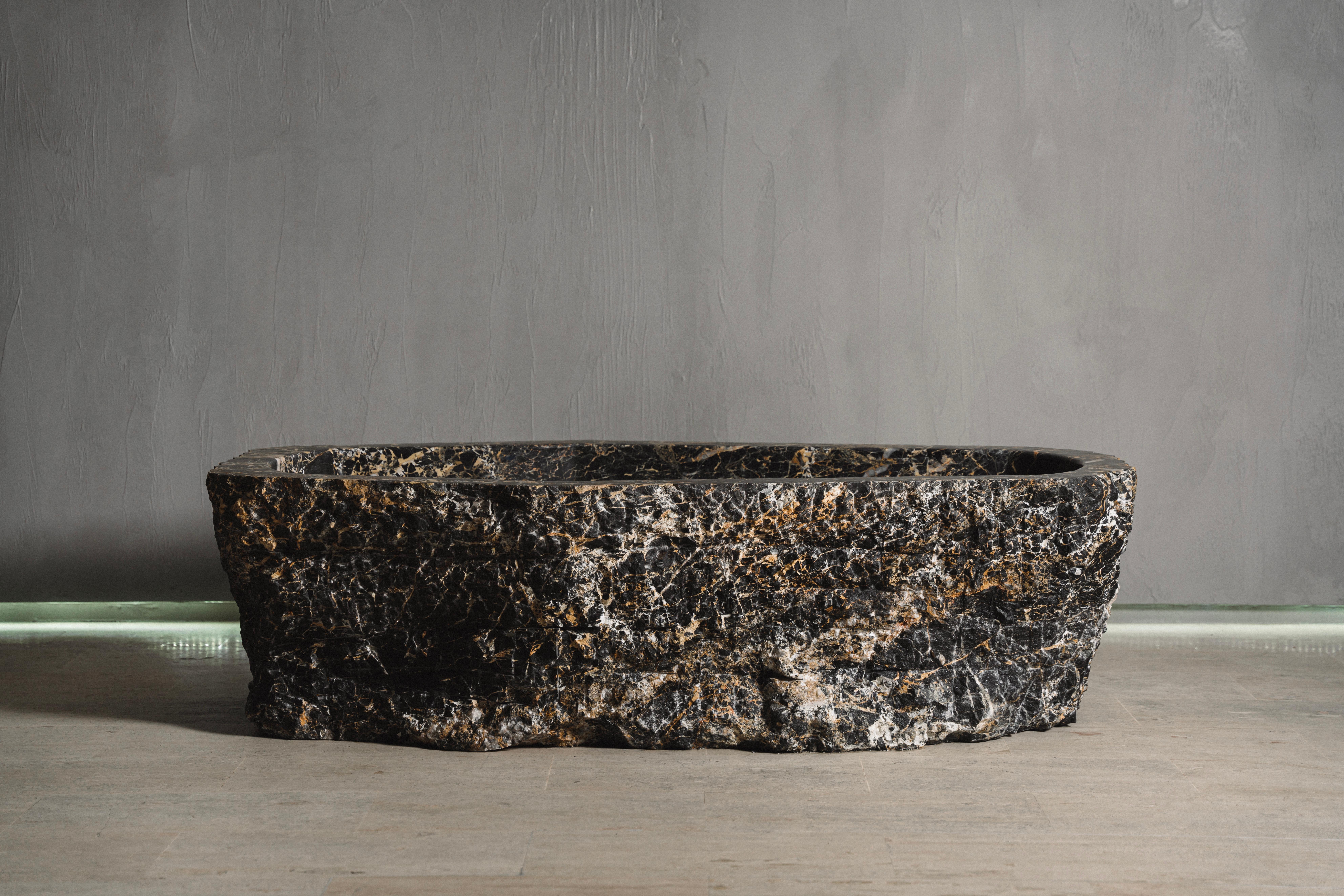 Baptiz rock bath tub by Andres Monnier
One of a Kind.
Dimensions : L 190 x W 110 x H 50 cm
Dimensions Available: L 170-200 x W 80-110 x H 45-55 cm.
Materials: Portoro Black Marble.
Stone Options Available: Grey, Black and White Marble, Natural
