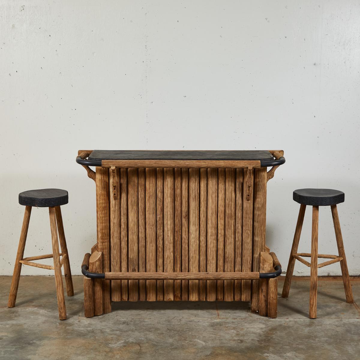 A bar and two-bar stools set in wood.