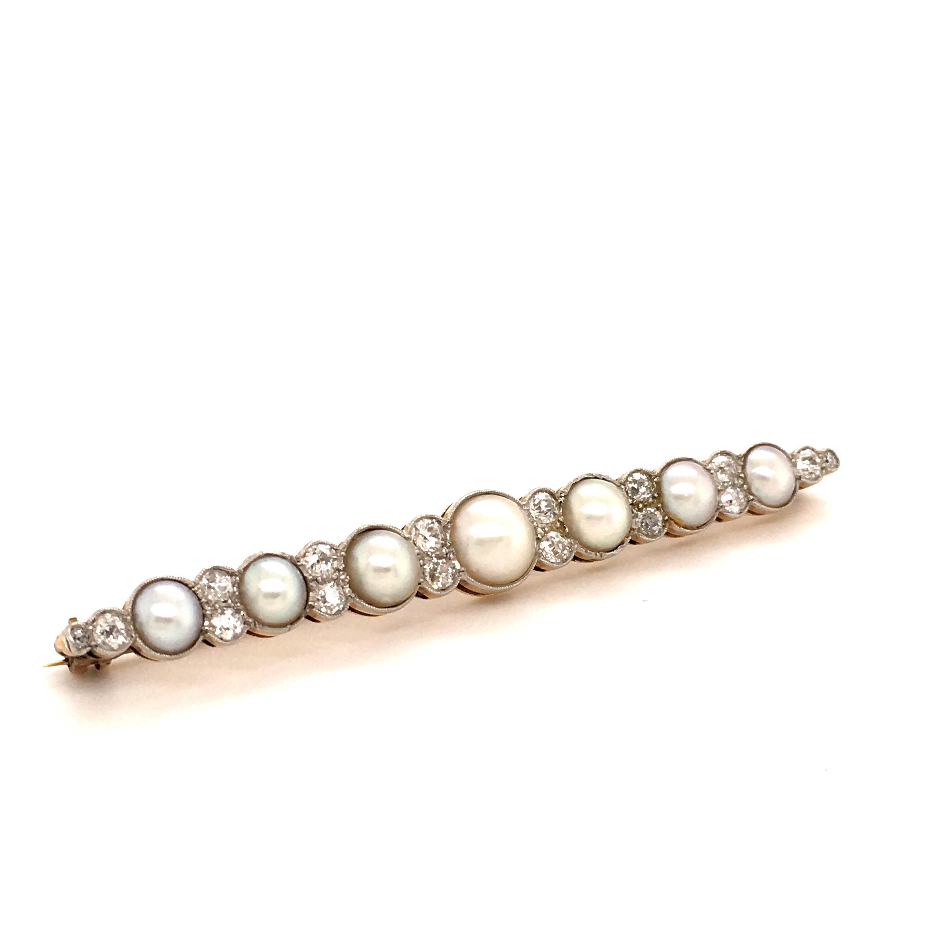 7 beautiful shining white coloured natural half pearls with a bright luster and a clean surface are surrounded by 16 old cut diamonds totalling approximate 3.00 ct set with mill grain decoration.
The base is worked in 14K yellow gold and is topped