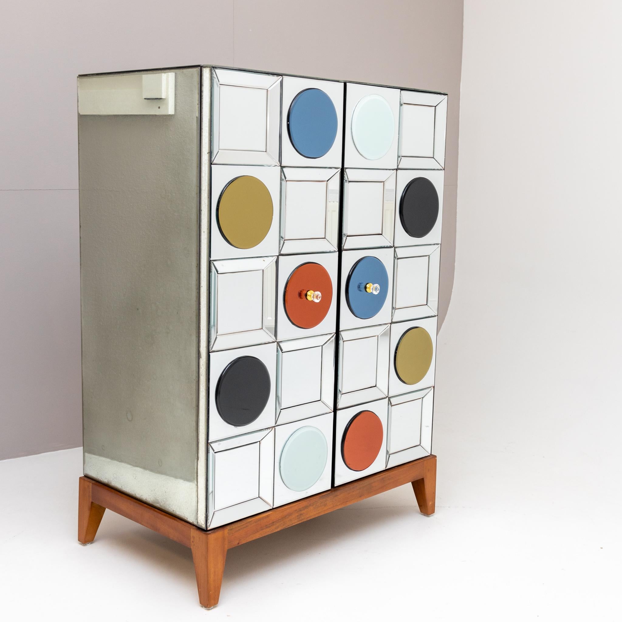 Two-door bar cabinet by Belgian designer Olivier de Schrijver (b. 1958) on wooden frame with mirrored glass surfaces and circular colored panes.