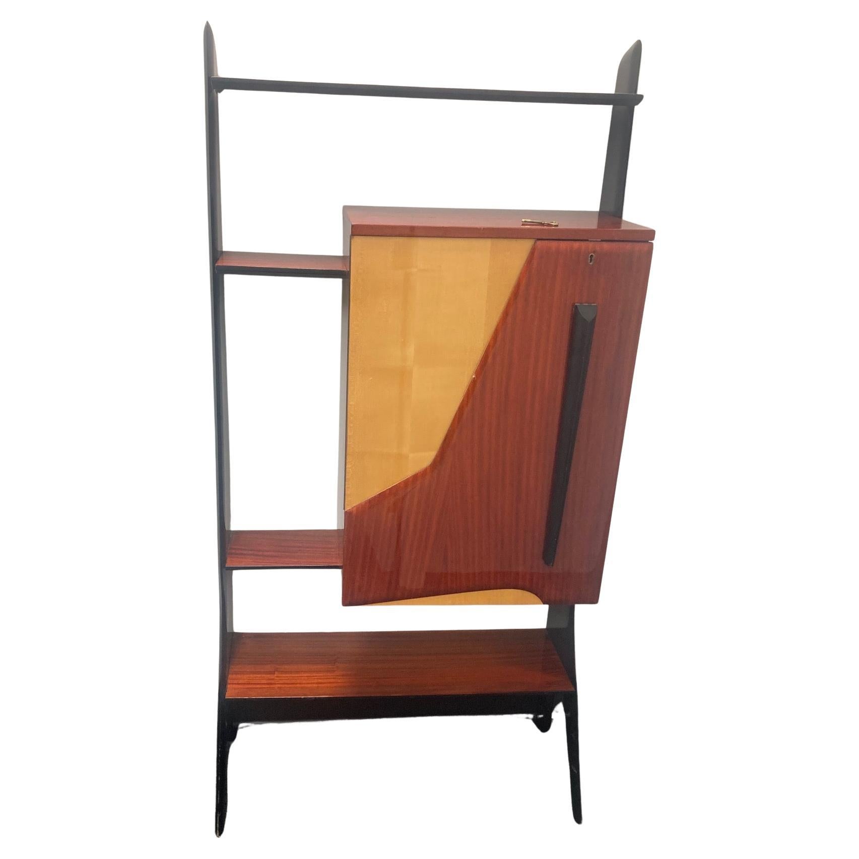 Bar Cabinet
Ico Parisi (Italy)
Original Design:  1950's/1960’s
Lacquered mahogany, birch, enameled wood, laminate, 
mirror, glass shelves, original door key (amazing that it was never lost!) 
Dimensions:  W 33” x D 14.25” x H 66”
Pristine