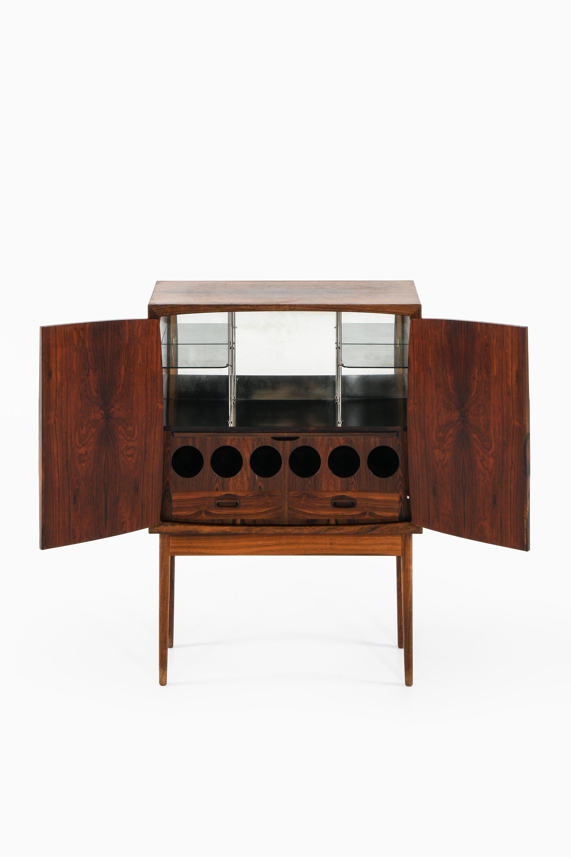 Scandinavian Modern Bar Cabinet in Rosewood, Glass and Steel by Torbjørn Afdal, 1960's For Sale