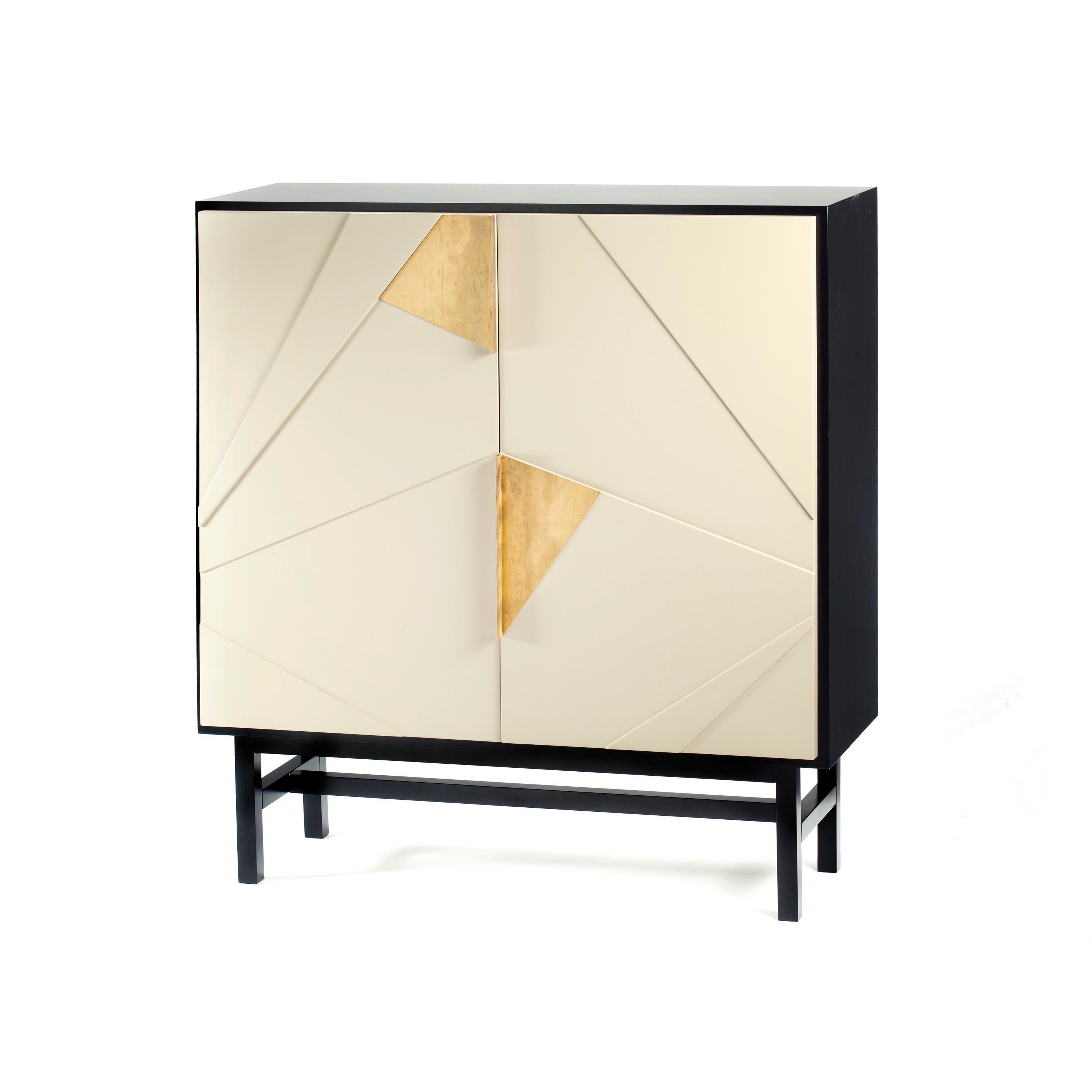 Jazz bar cabinet is a high quality product by Mambo Unlimited Ideas, crafted in polished or matte wood veneer structure and feet, brass applications and lacquered doors. It features three dimensional designs on its doors, elegant oxidized brass