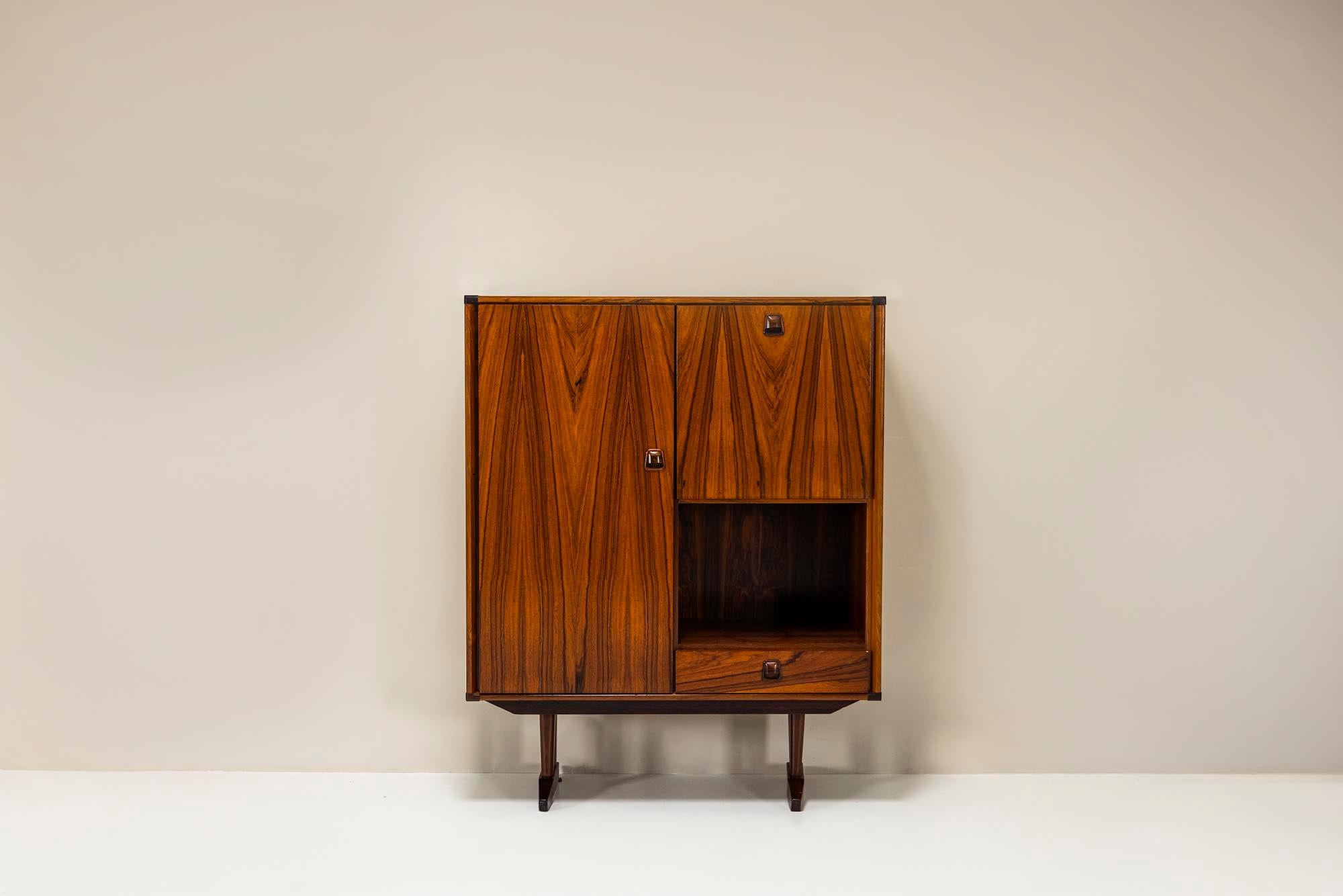 This exquisite bar cabinet by Topform is a quintessential example of refined mid-century Dutch design from the 1960s. Crafted from luxurious rosewood, the piece showcases the rich natural grain and warm tones characteristic of this sought-after