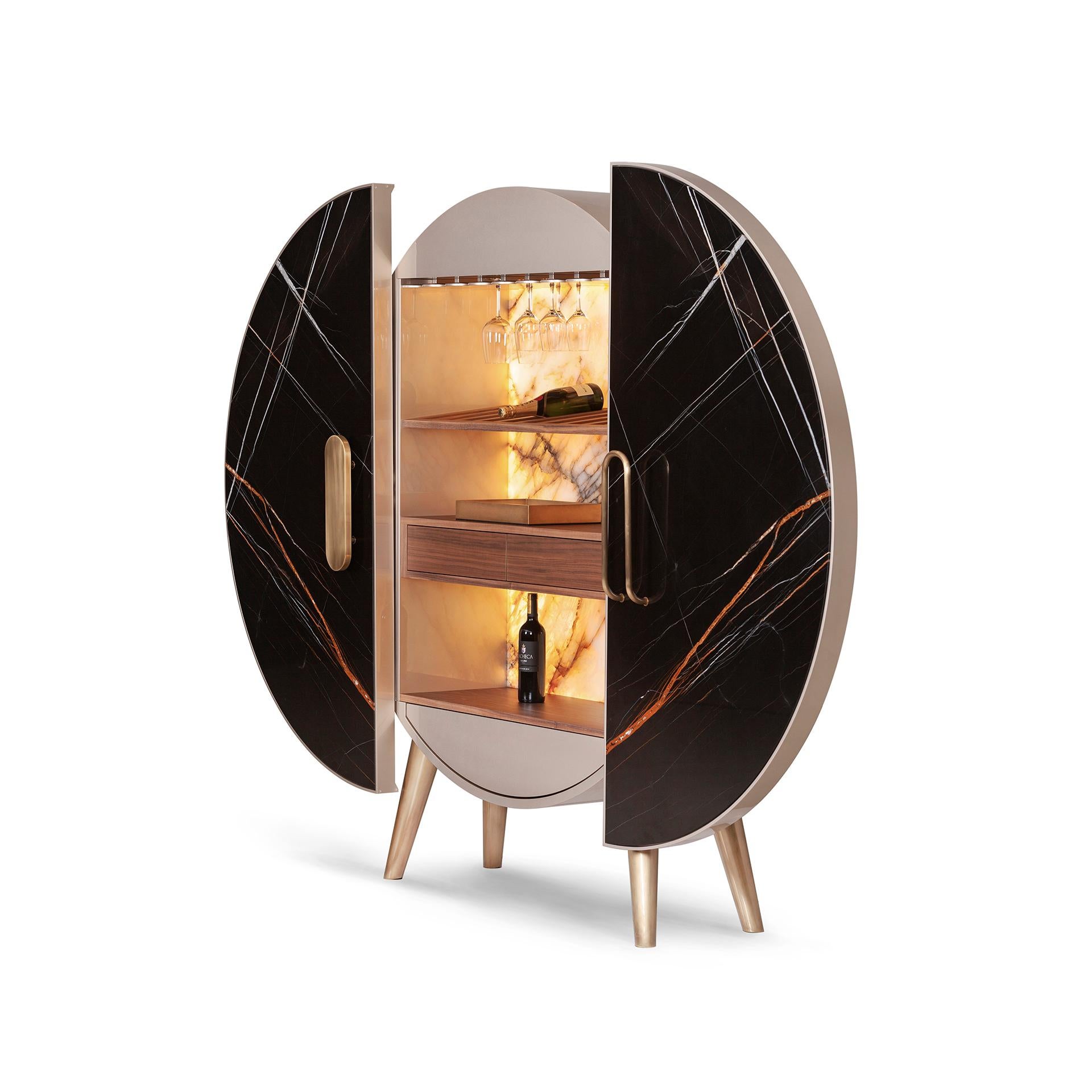 Bar Cabinet w/LED lighting by Green Apple
Limited Edition
Dimensions: H 196 x W 171 x D 54 cm
Materials: walnut, marble, granite, brass, LED, bronze.

Wooden bar cabinet with round structure lacquered in high-gloss champagne-coloured bronze