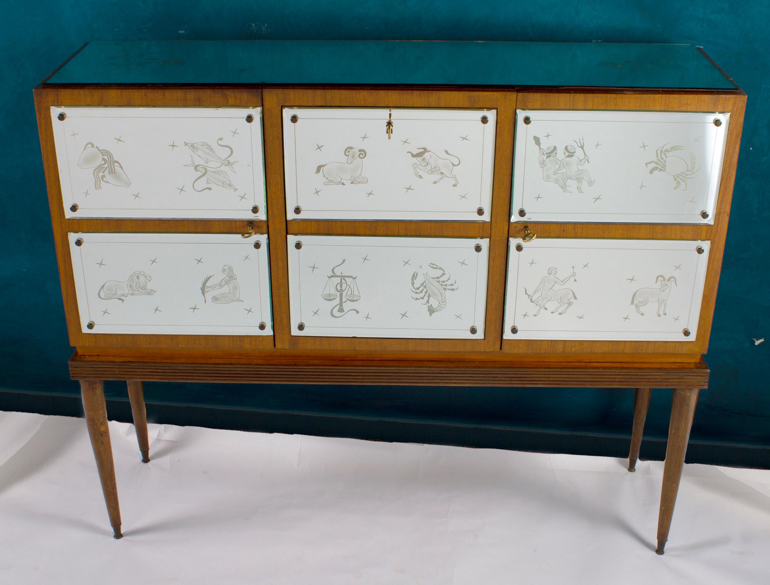 Rare Bar Cabinet, front doors decorated with a finely etched Zodiac motifs mirrored glasses. 
Resting on four legs. Attributed to Gio Ponti.
Glasses in very good vintage condition.
