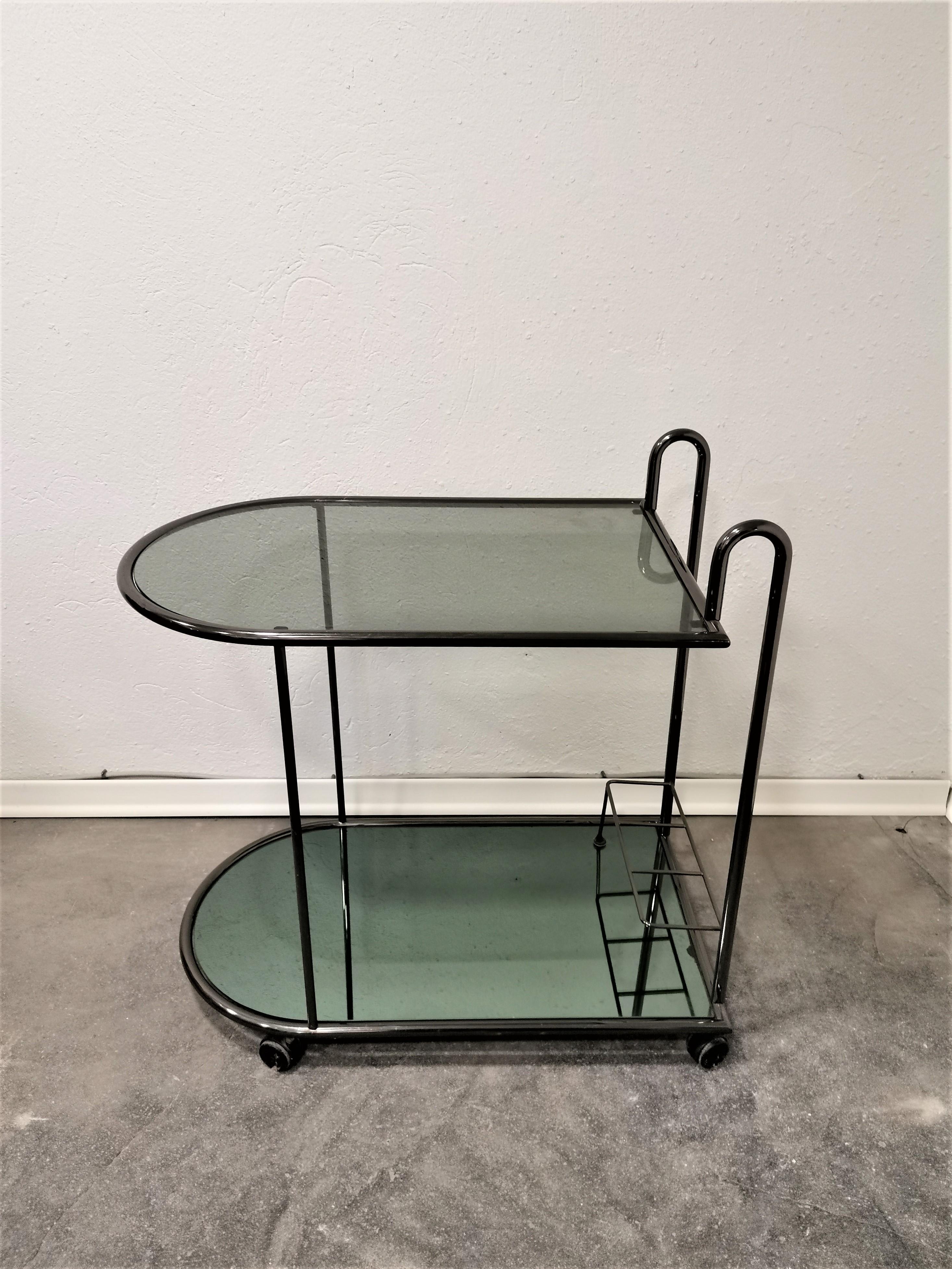 Bar Cart, 1980s

Period: 1980s

Country of manufacturer: Italy

Style: Midcentury Modern, Classic, Industrial, Modern

Materials: chrome, smoked glass, mirror, plastic wheels

Condition: Very good vintage condition. All parts are original. Some