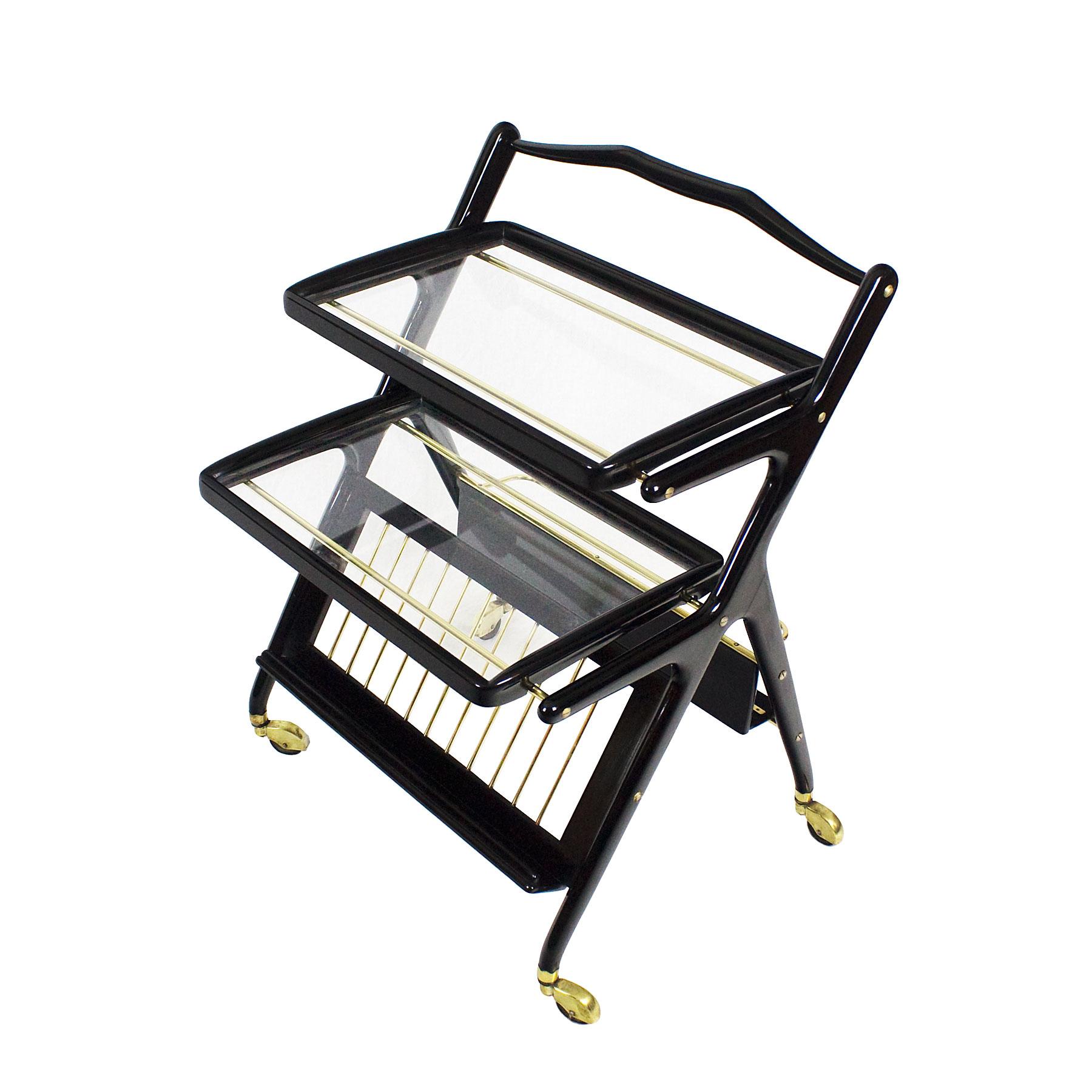 Bar cart with magazine rack and two removable trays. Solid and stained mahogany. French polish. Polished brass and glass.

Design: Cesare Lacca for Cassina.

Italy circa 1948-50.