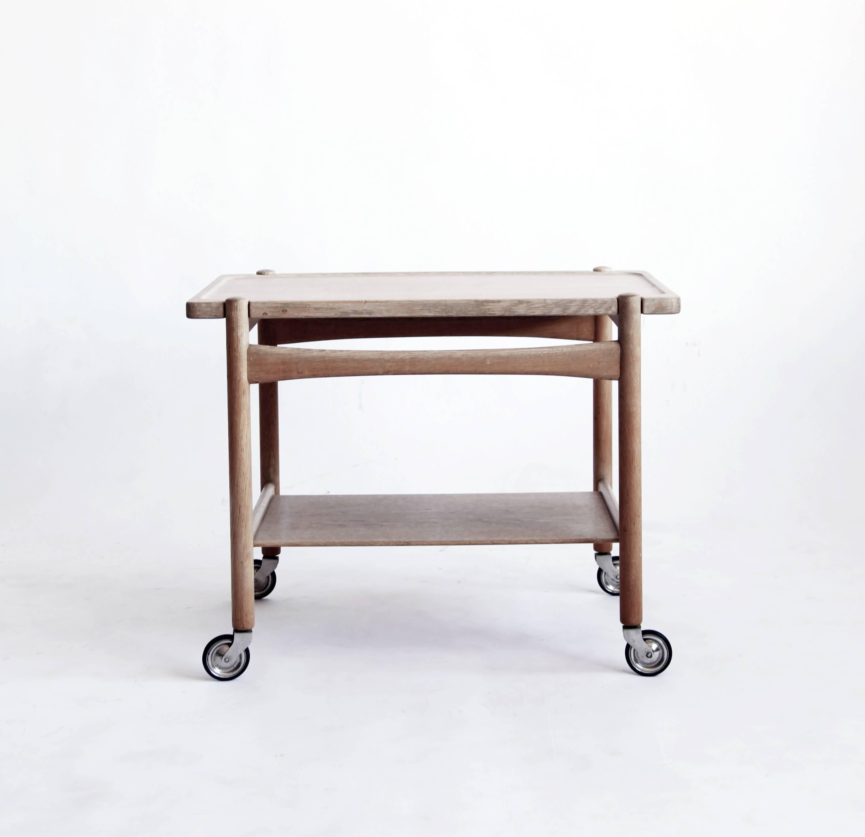 Andreas Tuck was a Danish cabinetmaker primarily active in the 1950s and 1960s, and Hans Wegner was their chief designer. Together, they produced a range of tables that embody a Minimalist Nordic elegance.

This pale oak bar cart has a removable