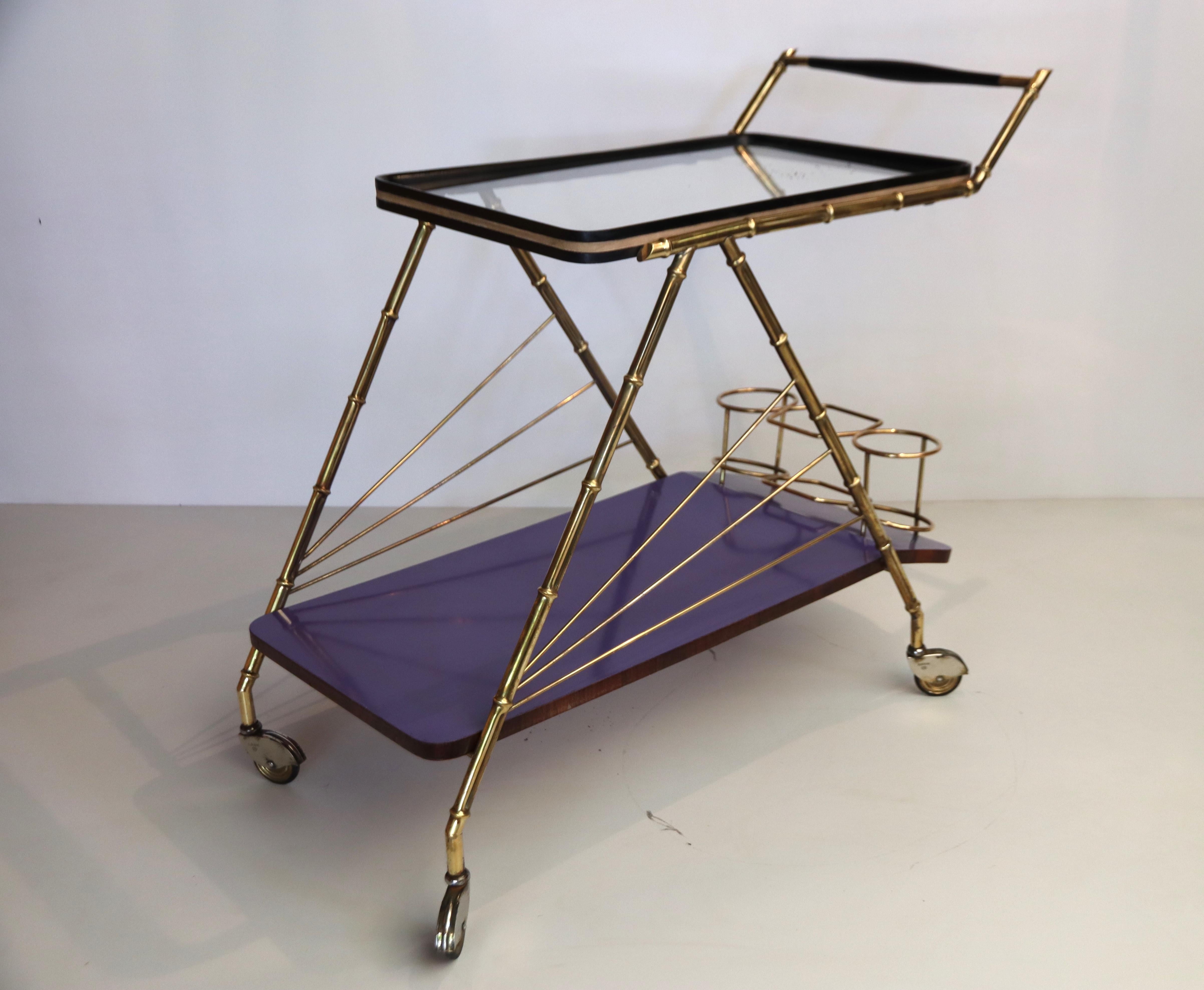 Very unusual elegant and colourful two tiered drinks trolley or bar cart on casters, made of beautiful purple laminated bent wood and copper with the original glass top. 3 brass bottle holders on the bottom tier; in very good condition, alls