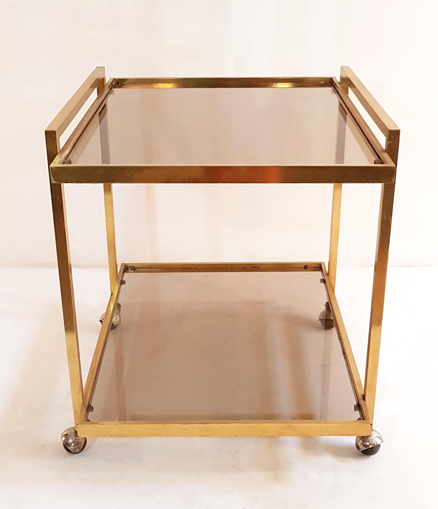 Elegant two-tiered bar cart with smoked glass shelves.