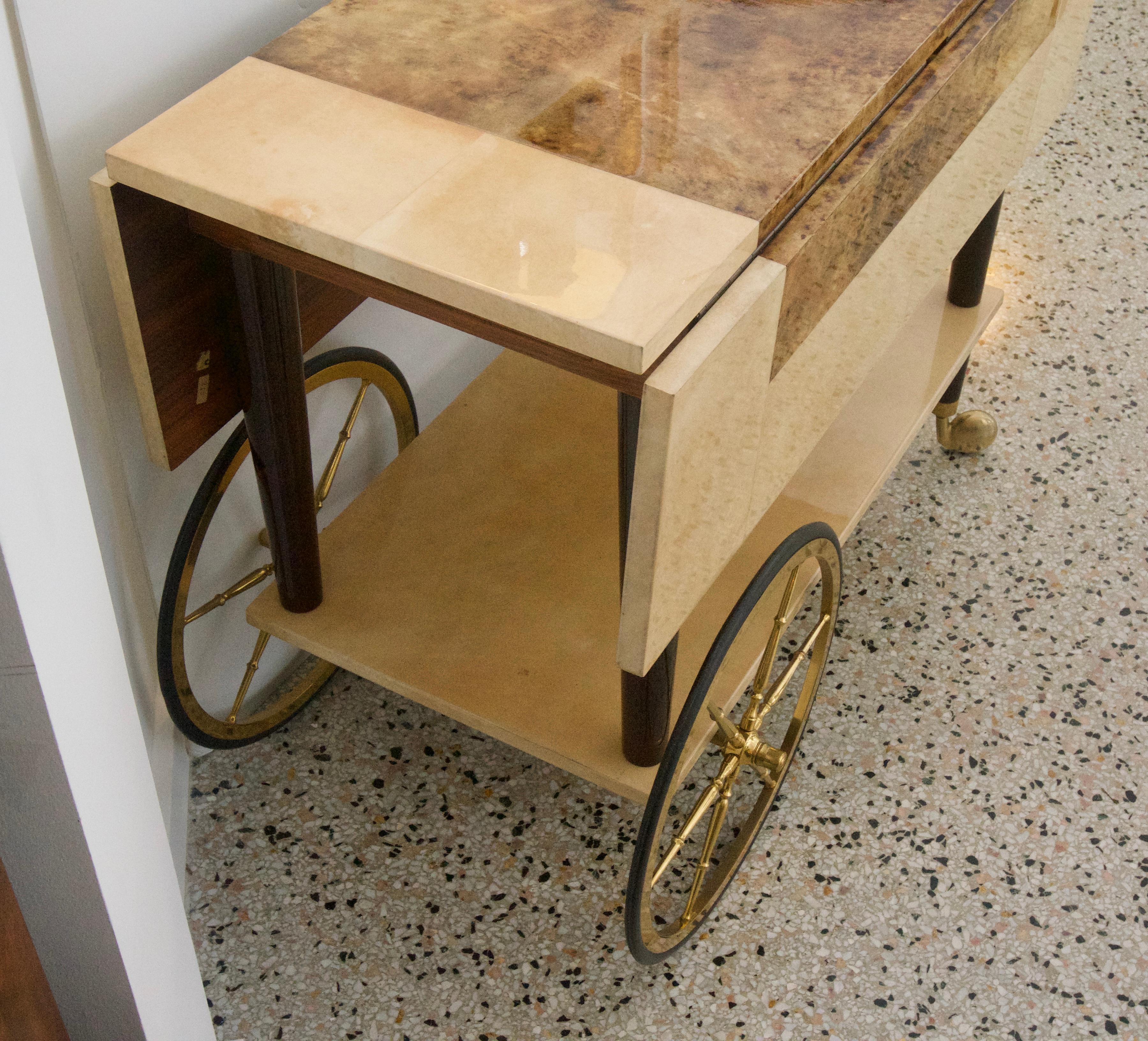 This stylish Aldo Tura bar cart dates to the 1950s-1960s and is in wonderful condition and would seem to have been used minimally. The piece was acquired from a Palm Beach estate and can now be yours for your next fete.

Note: There are drawers on