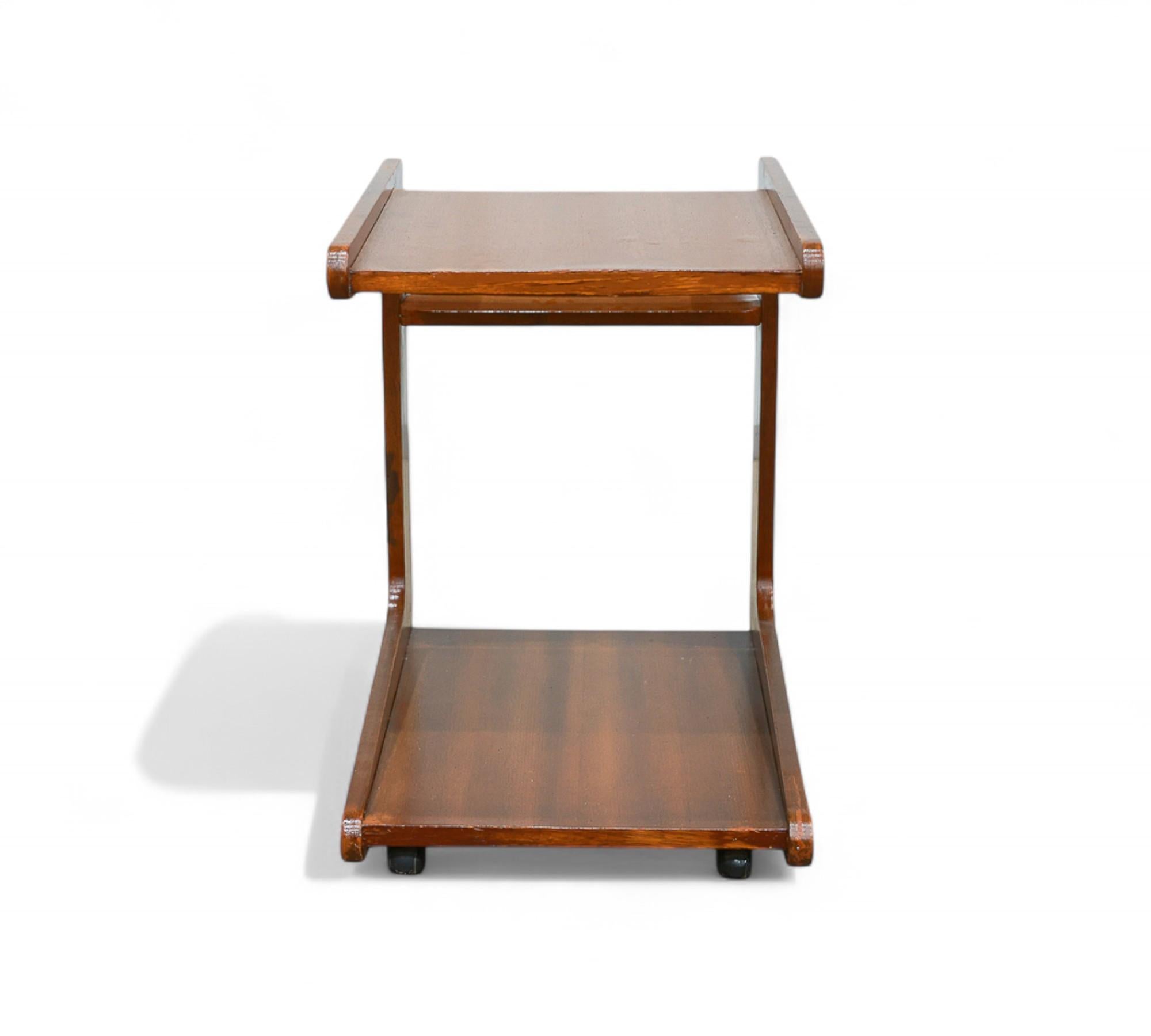 This exquisite bar cart is crafted from premium Brazilian hardwood. Its sleek rectangular shape, clean lines, and two storage levels are enhanced by a convenient back compartment, combining style and functionality. The four original metal wheels add