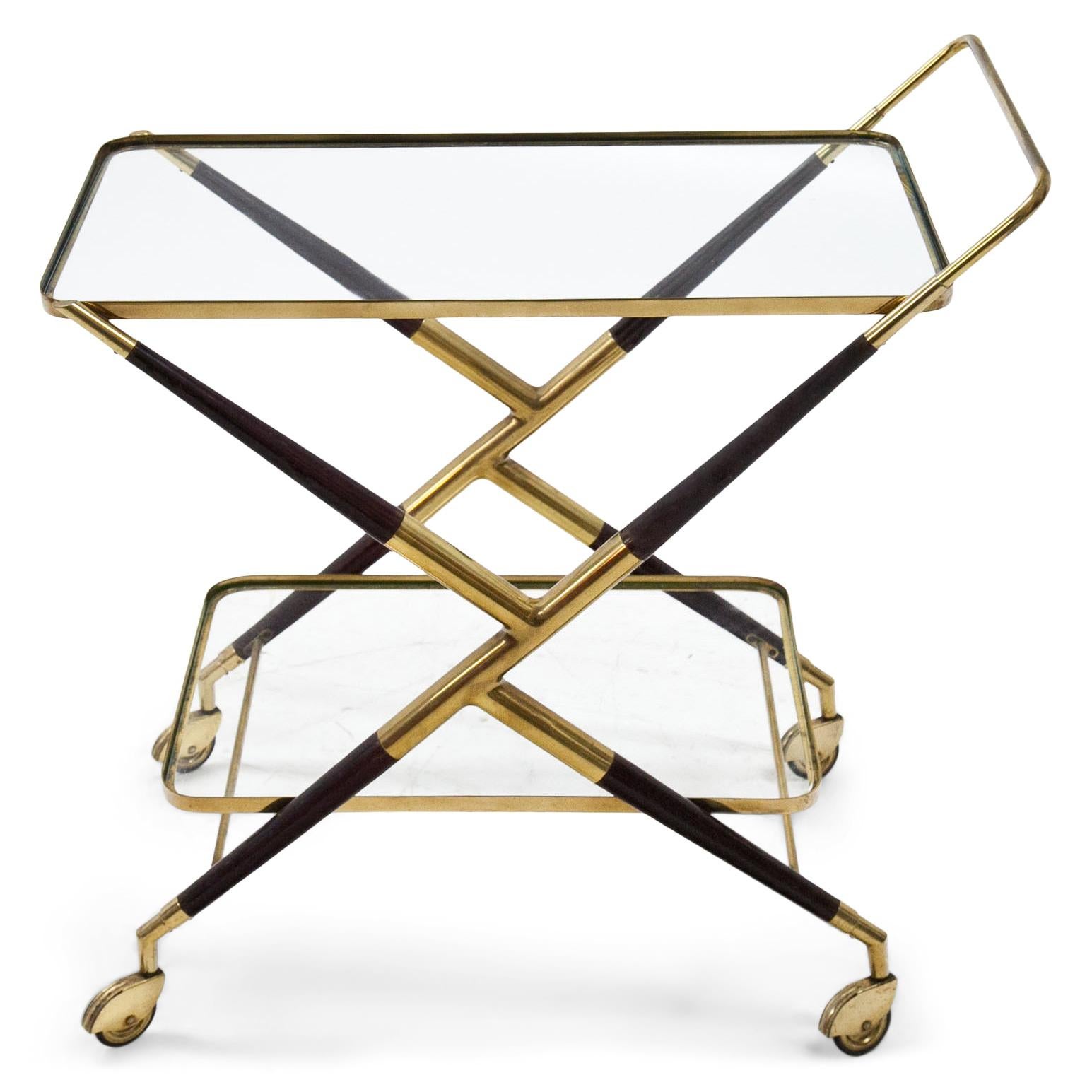 Bar cart with a wood and brass frame and two shelves with glass panes. The brass shows signs of age and use.