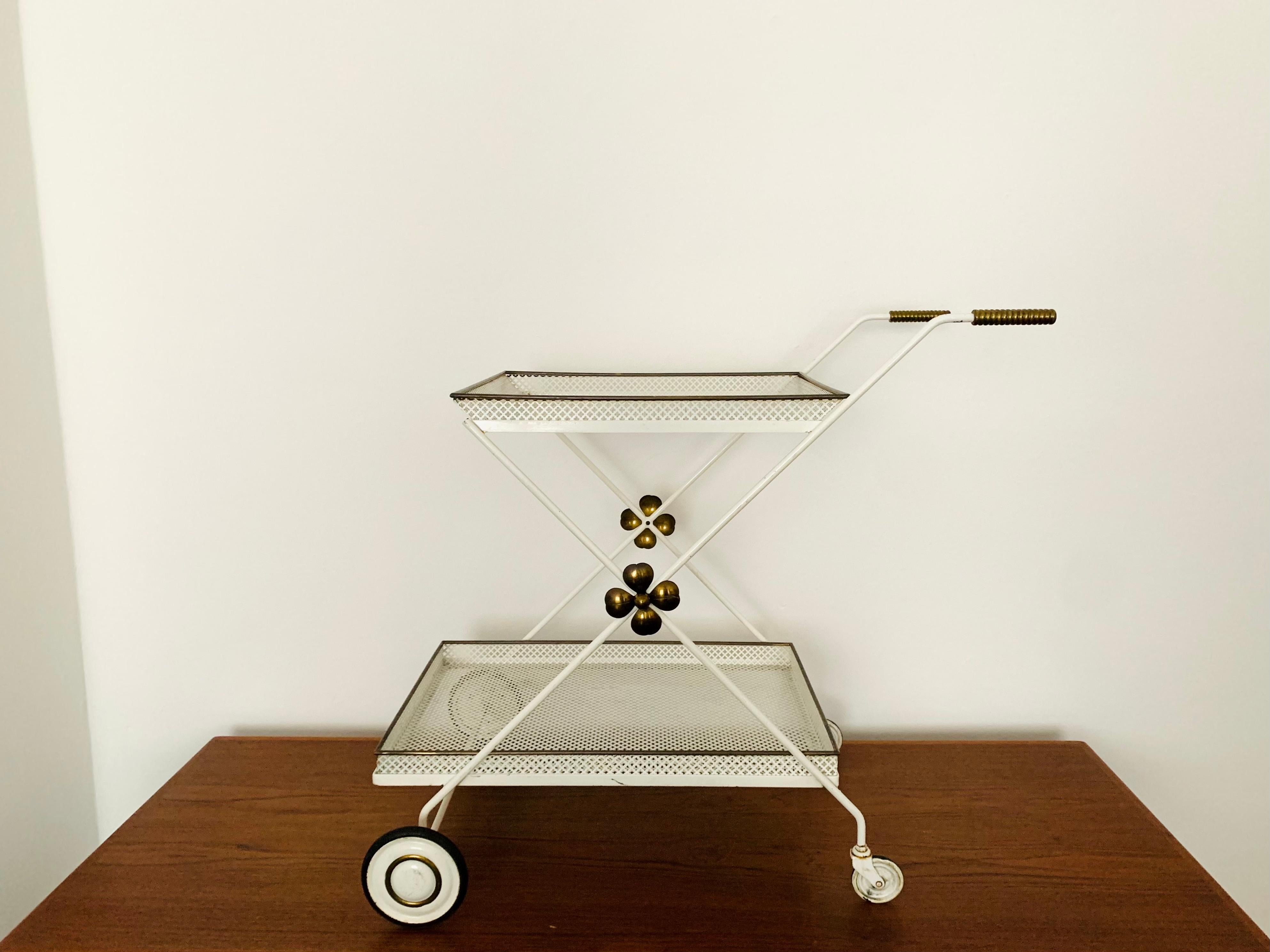Exceptionally beautiful and very high quality bar trolley or tea trolley from the 1950s.
Very nice detailed design and high-quality workmanship.

Manufacturer: Vereinigte Werkstätten München

Condition:

Very good vintage condition with signs