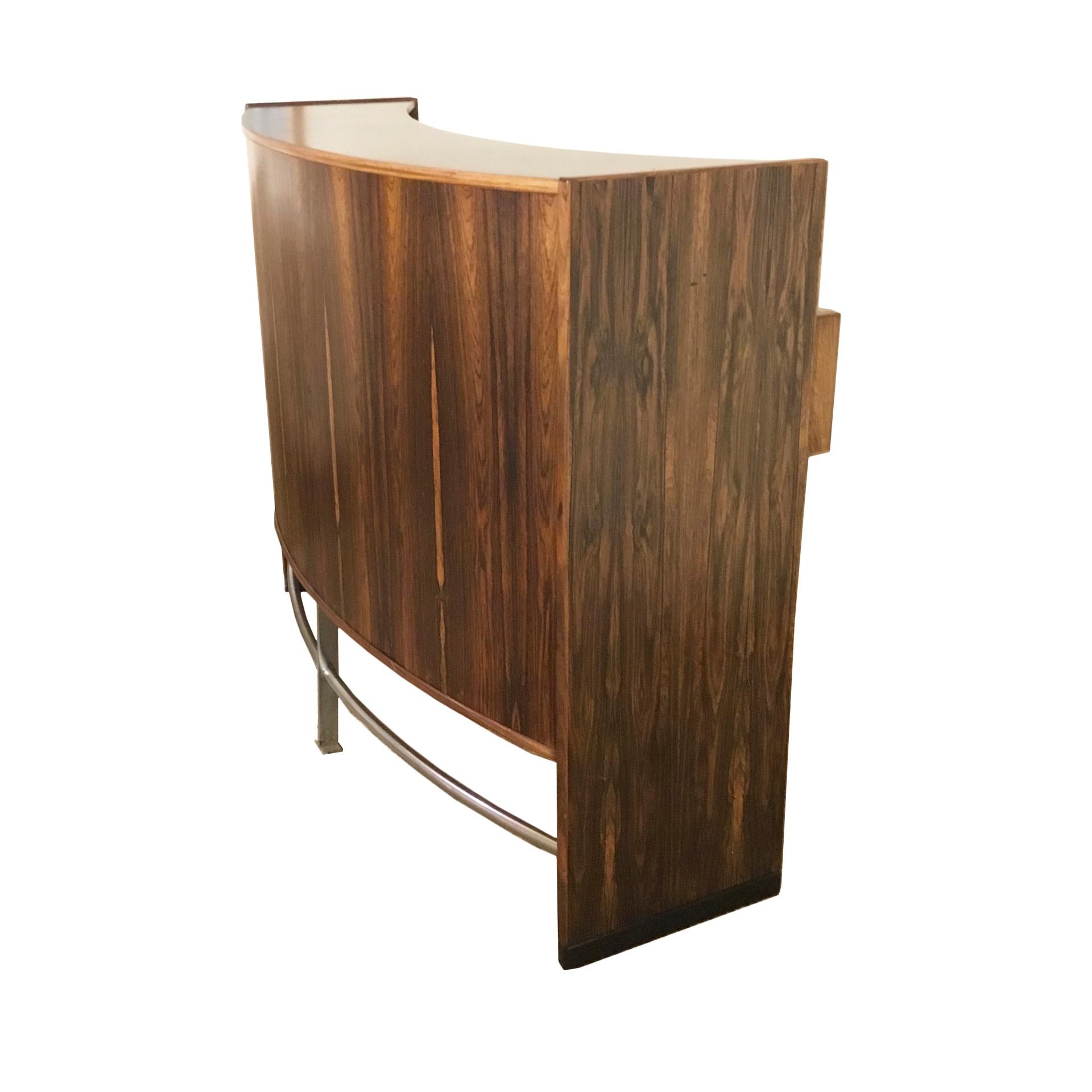 Danish bar furniture mod. Dyrlundbar designed by Erik Buch with solid wood structure covered with marquetry circles on the front and steel details. On the back 2 sliding doors and 2 drawers with chrome-plated handles. 7 curved steel bottle holders.