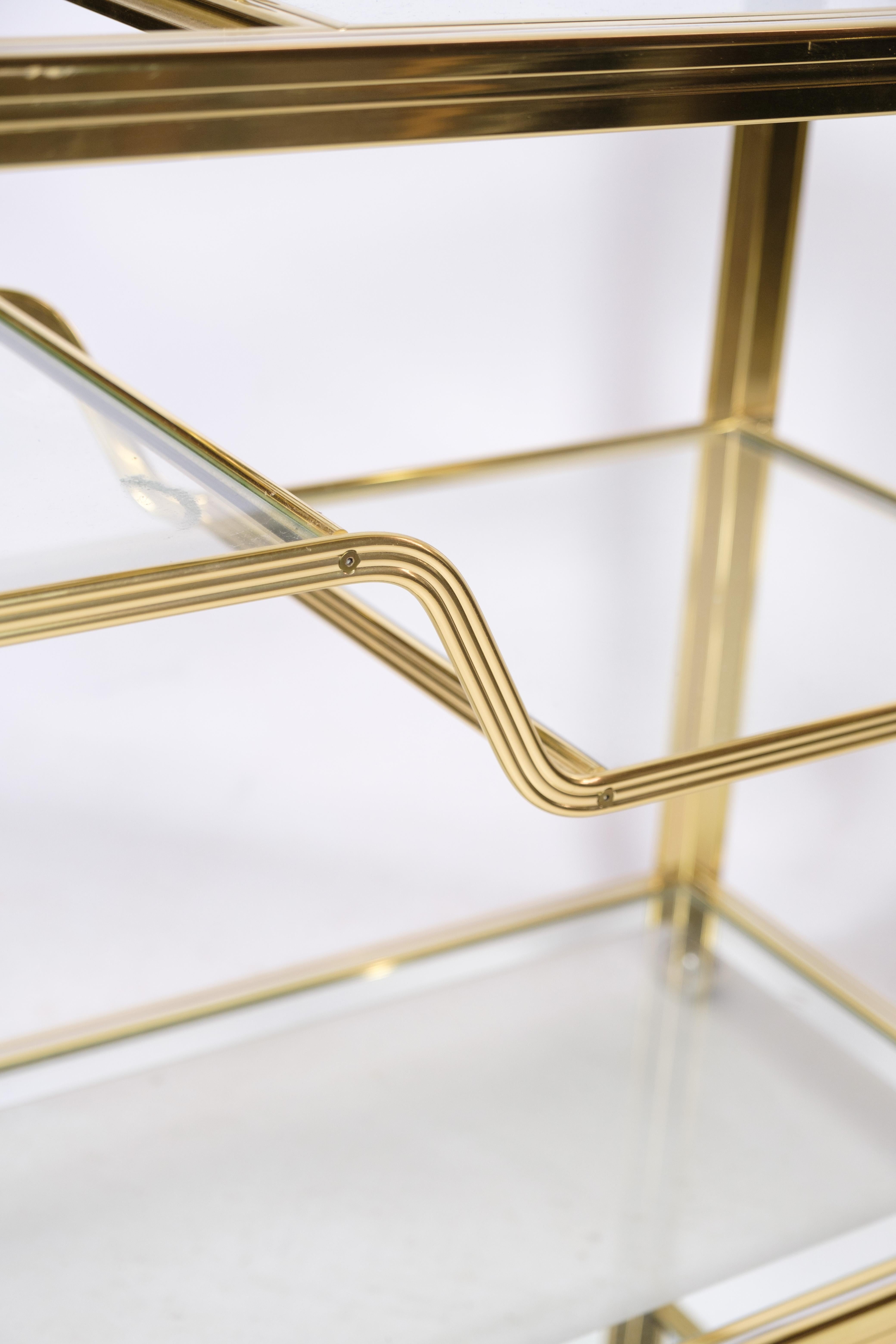 Pierre Vandel bar with castors, a stunning and distinctive piece of furniture that seamlessly combines functionality with style. Its split-level design offers generous storage and display space, while the elegant gold and chrome finish adds a touch