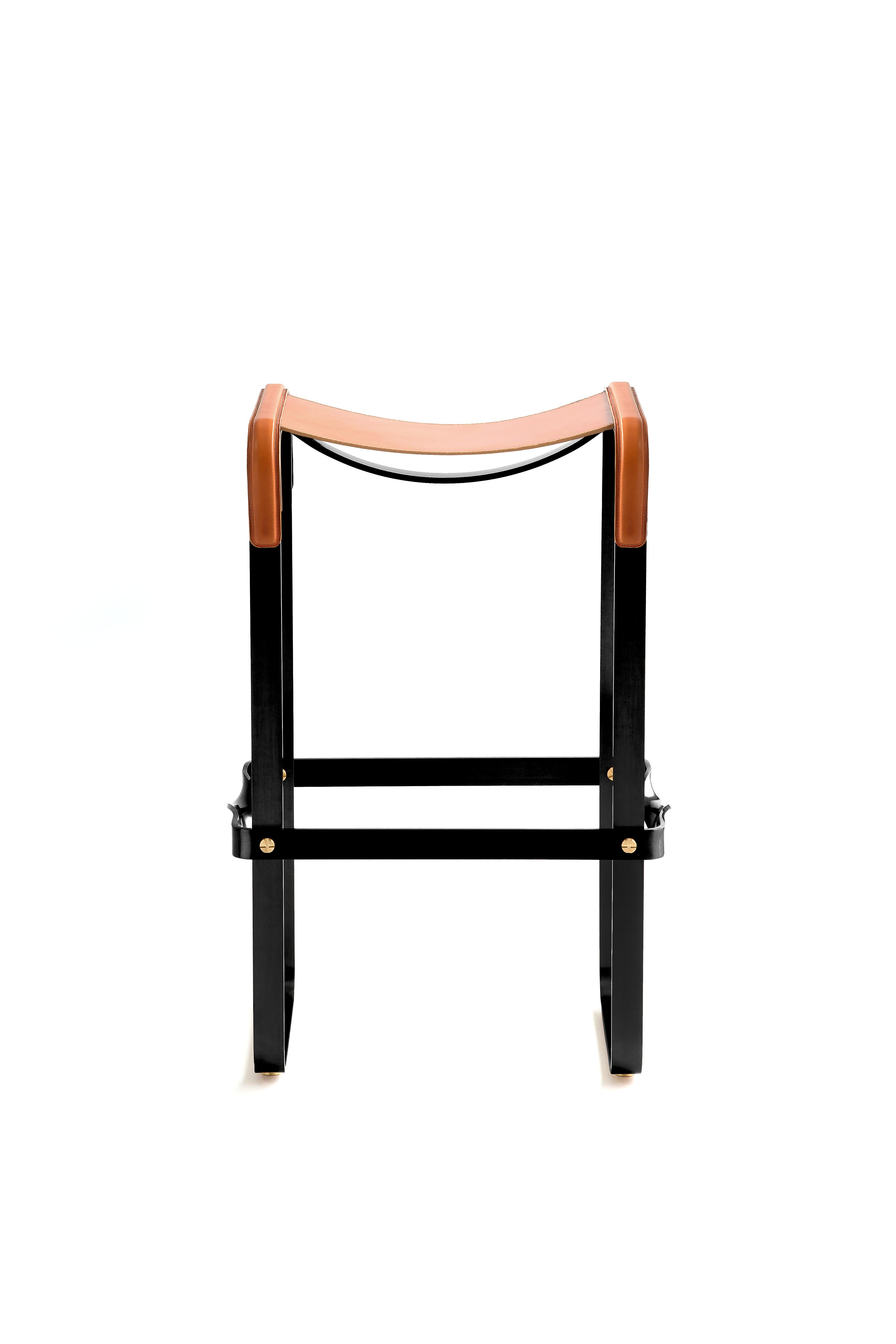 The Wanderlust contemporary barstool belongs to a collection of minimalist and serene pieces where exclusivity and precision are shown in small details such as the hand-turned metal nuts and bolts that fix the leather surfaces, that go unnoticed at