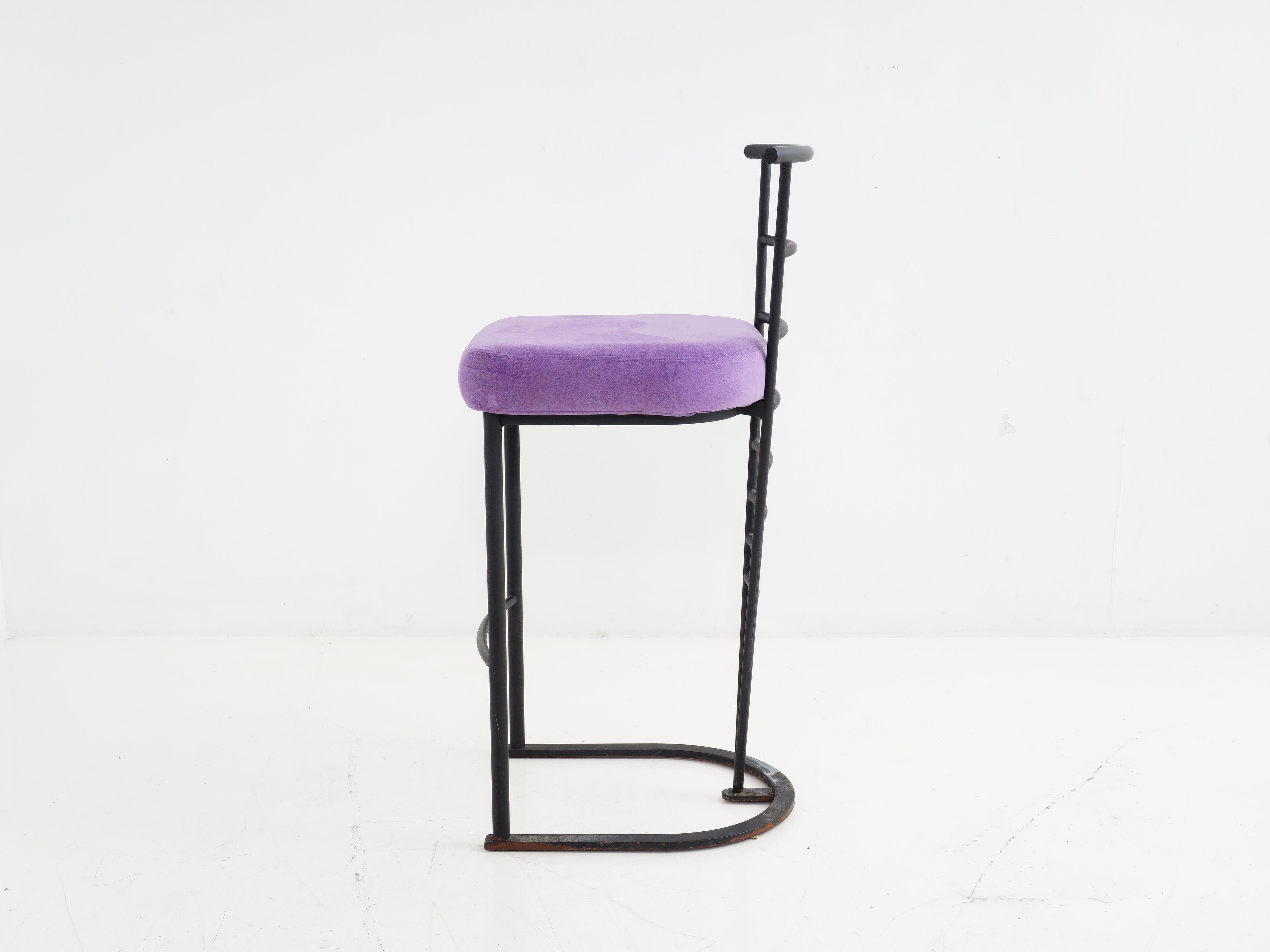Elevate your seat game with this 1970s Art Deco style black metal bar stool. It's the velvet underground of bar seating, draped in opulent purple suede. Step back in time and sip your cocktails with a side of vintage glam.

- 40