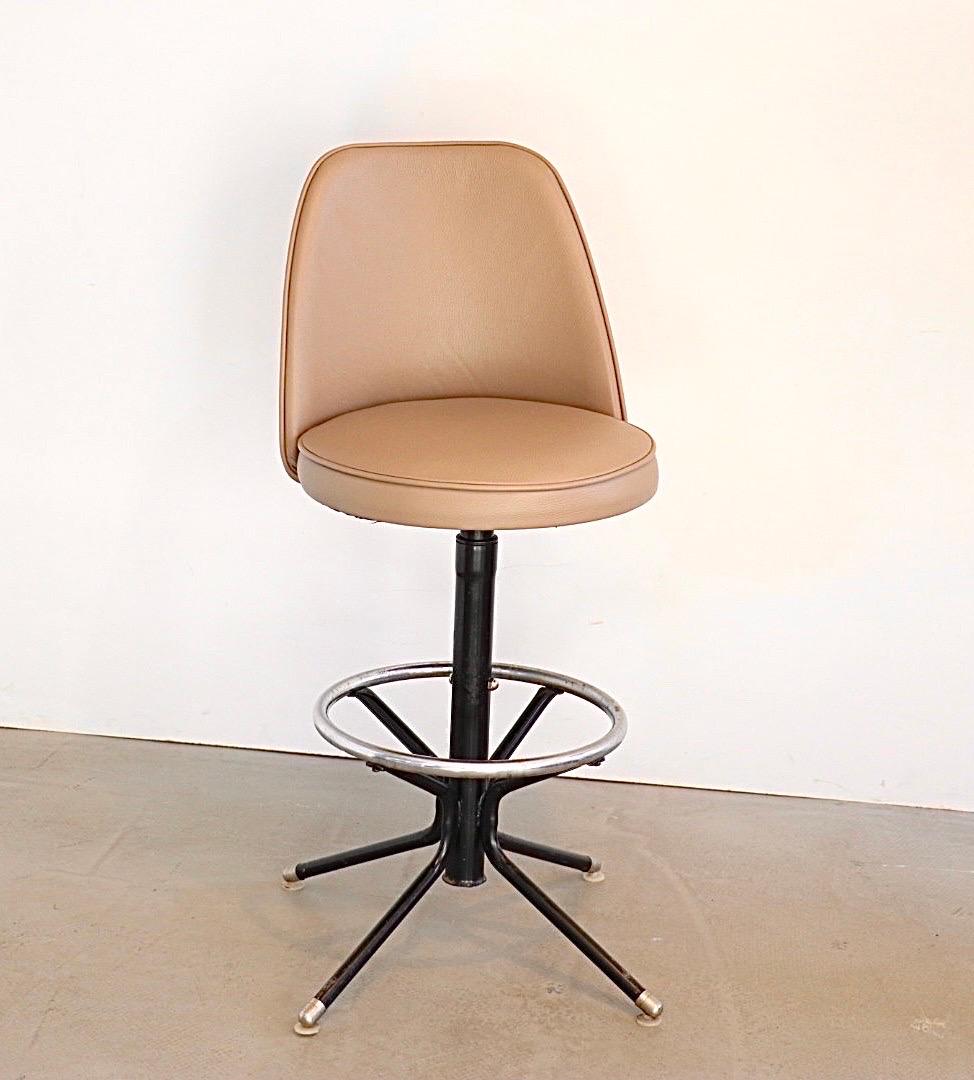 Beautifully made metal bar stool by the Admiral Chrome Corporation from Detroit. This is the 1st edition from the 1950s (look at the type of leg-ends). 
The stool is adjustable in height by pulling the chrome bolt. highest seat height is 75cm, and