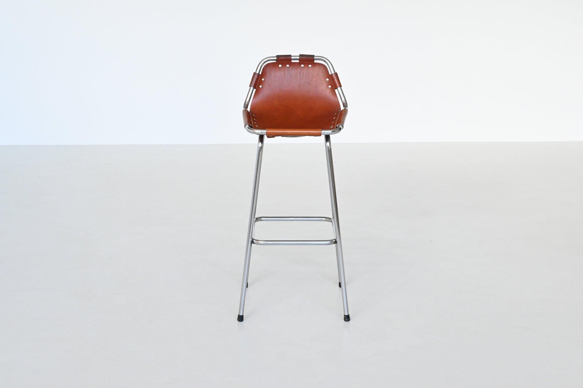 Beautiful shaped bar stool used by Charlotte Perriand for Les Arcs ski resort, France 1960. The stool has a chrome plated tubular metal frame and thick natural saddle leather seat. This fantastic bar stool is strong, comfortable and look amazing in