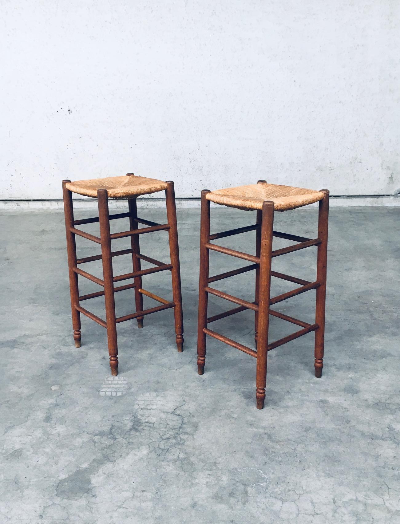 Vintage midcentury French Rustic made Bar Stool set in the style of Charlotte Perriand. Made in France, 1950s era. Solid oak constructed frame with rush woven seat. Both are in very good, original condition. Each stool measures 81cm x 37,5cm x