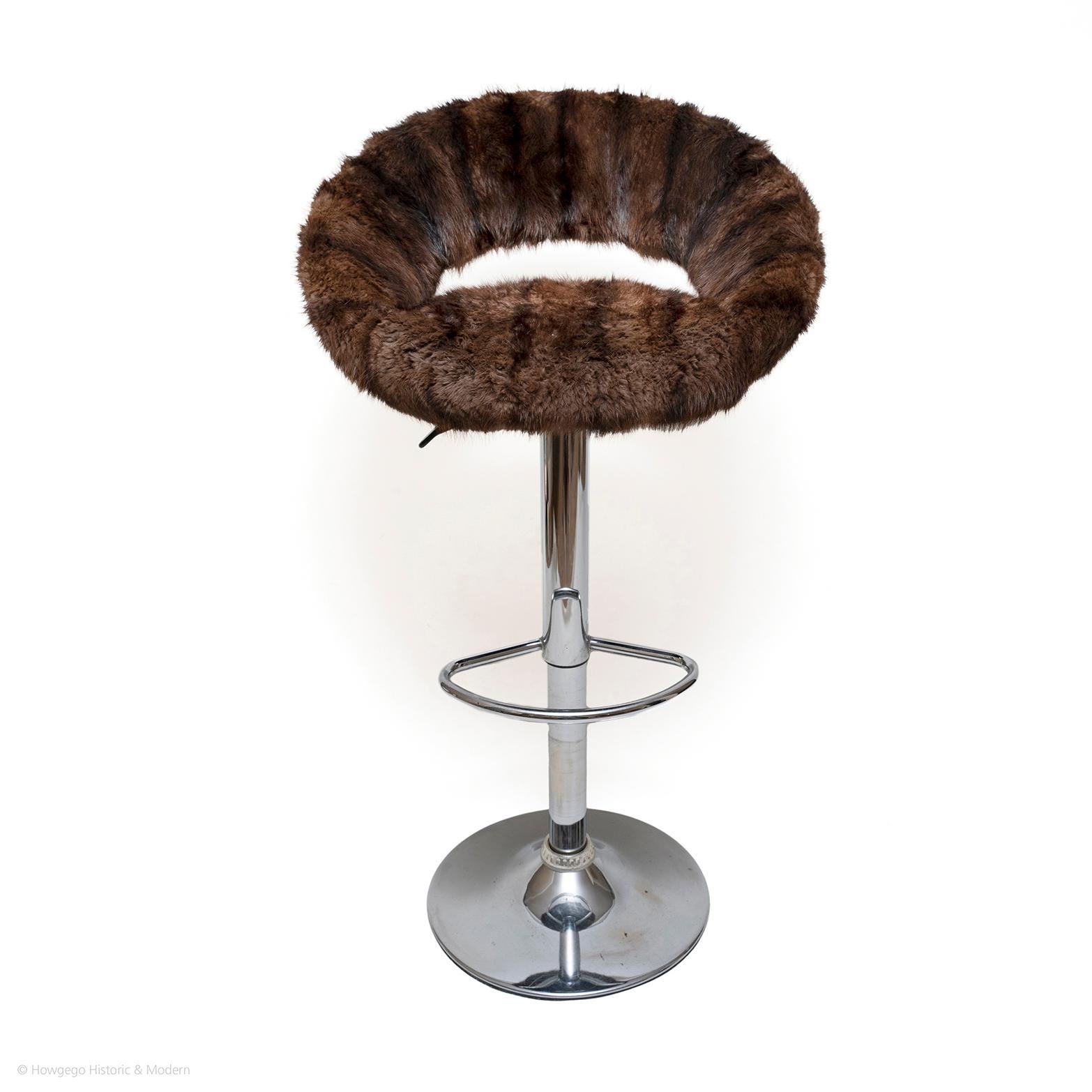 Classic form with a twist.
The mink upholstery is luxurious elevating the bar stool into a luxury item.
Practical with swivel function and adjustable.

Provenance private collection.
Maker unknown.

Measures: diameter 56 cm., 22