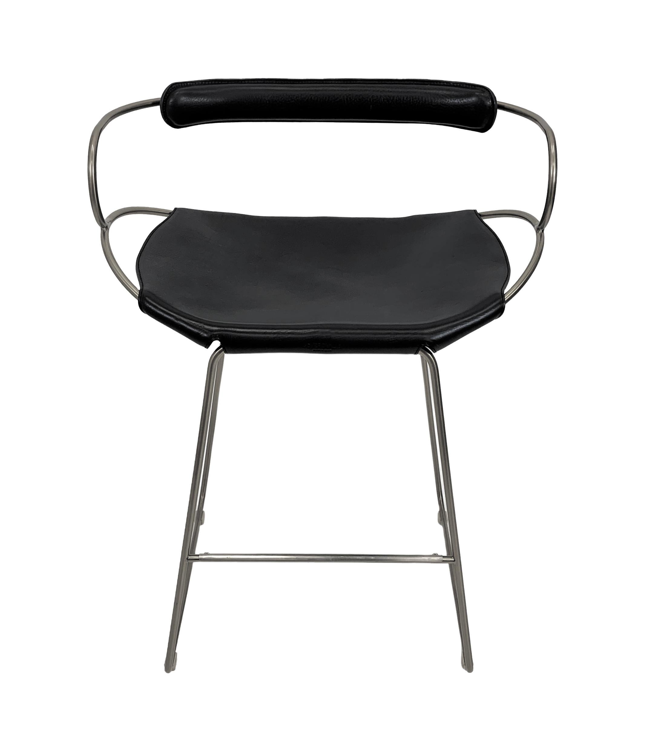 The Hug contemporary barstool with backrest is designed and conceived with a light aesthetic, the slight oscillation of the steel rod of 12 mm is complemented by the flexibility of the double 3.5 mm thick leather. When sitting in this furniture you