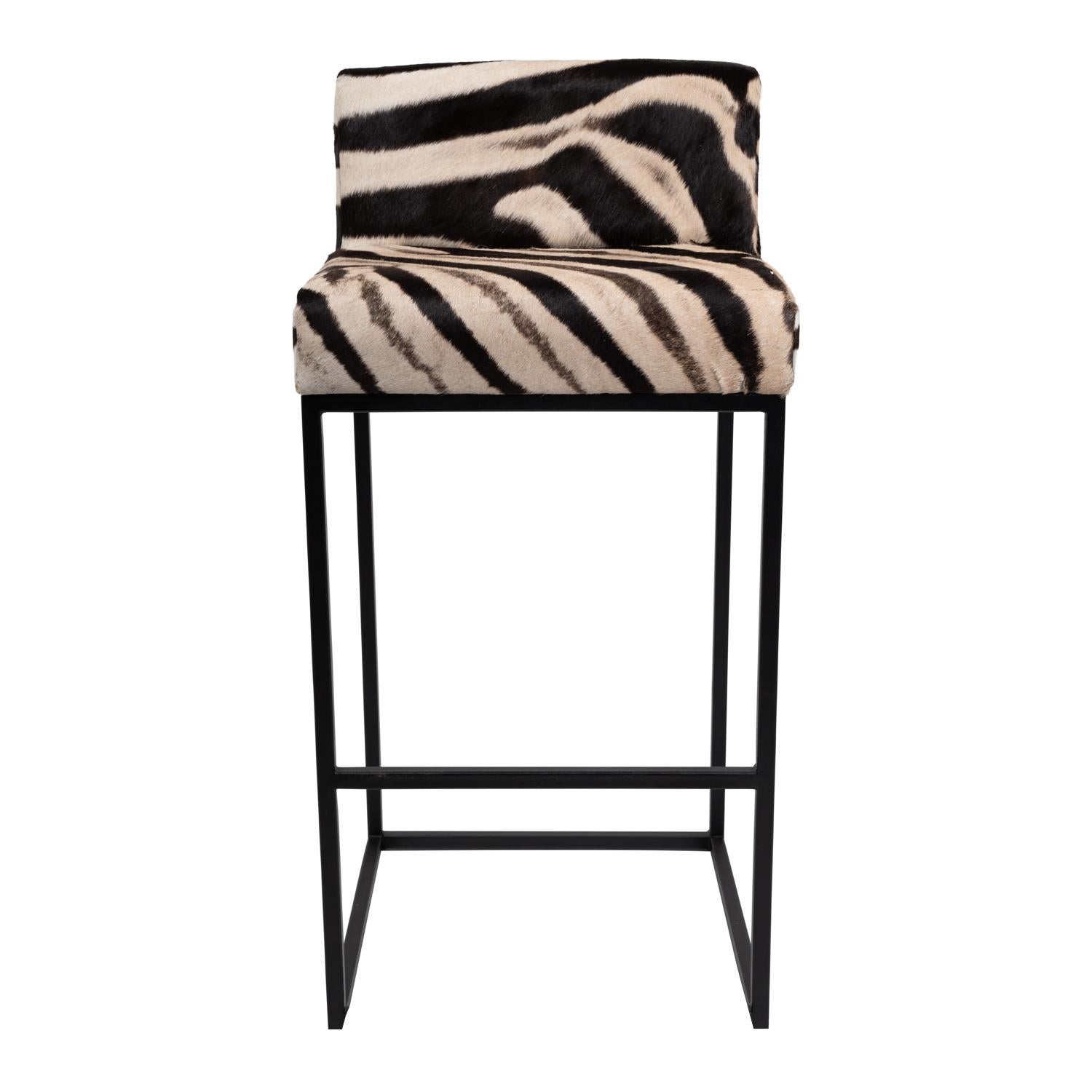 Genuine Burchell Zebra hide and classic black steel combine together to make the stunning Zebra Hide Bar Stool! Whether used for lounging, dining, or working, this bar stool provides a gorgeous yet comfortable seat sure to draw attention to any