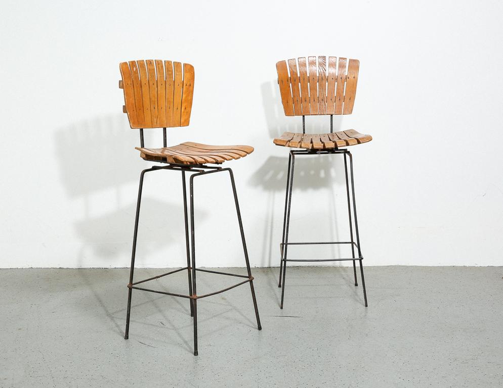 Vintage bar stools by Arthur Umanoff. Wood slat design over a solid steel rod frame. 30
