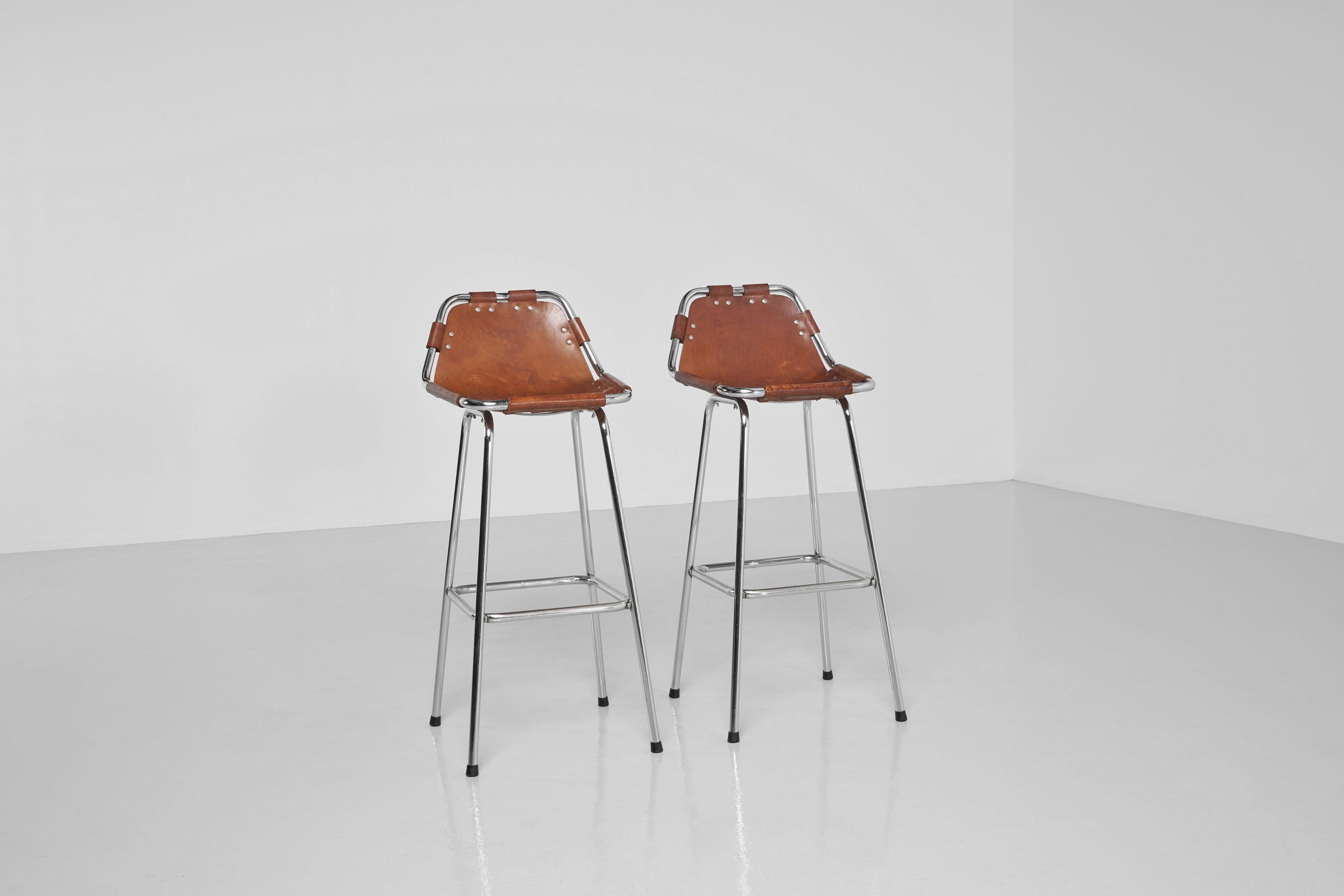 Beautiful and elegant set of bar stools made in France in 1960. These stools are designed with great attention to detail. Even though the designer is unknown, they were designed in the style of the chairs that Charlotte Perriand selected for the Les