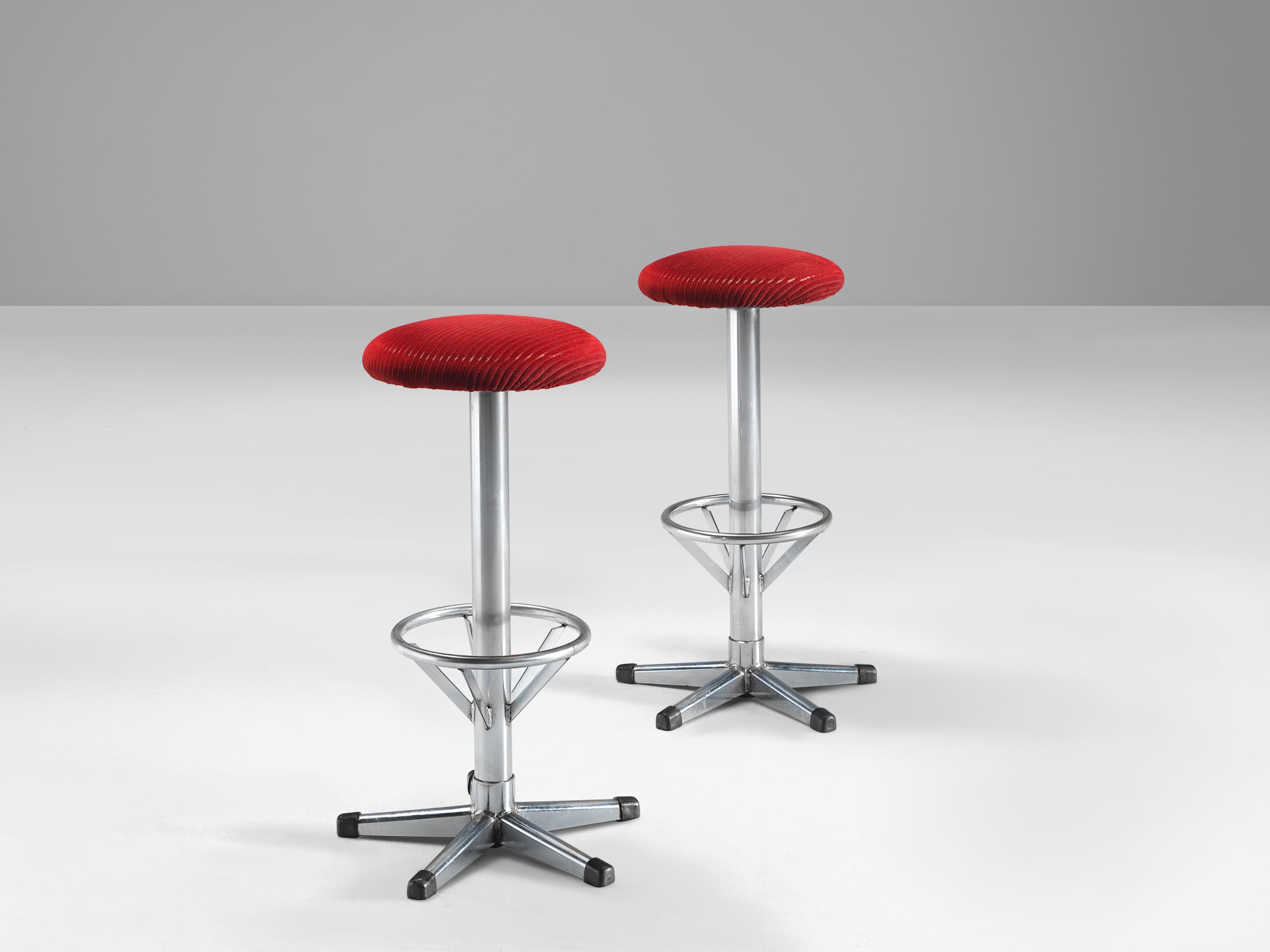 Bar stools, metal, velvet, Europe, 1970s.

Exquisite barstools in red velvet upholstery. Due to the soft seat and back, these chairs provide a very pleasant seating comfort. The five-legged footrest emphasizes the functional design. The circle is