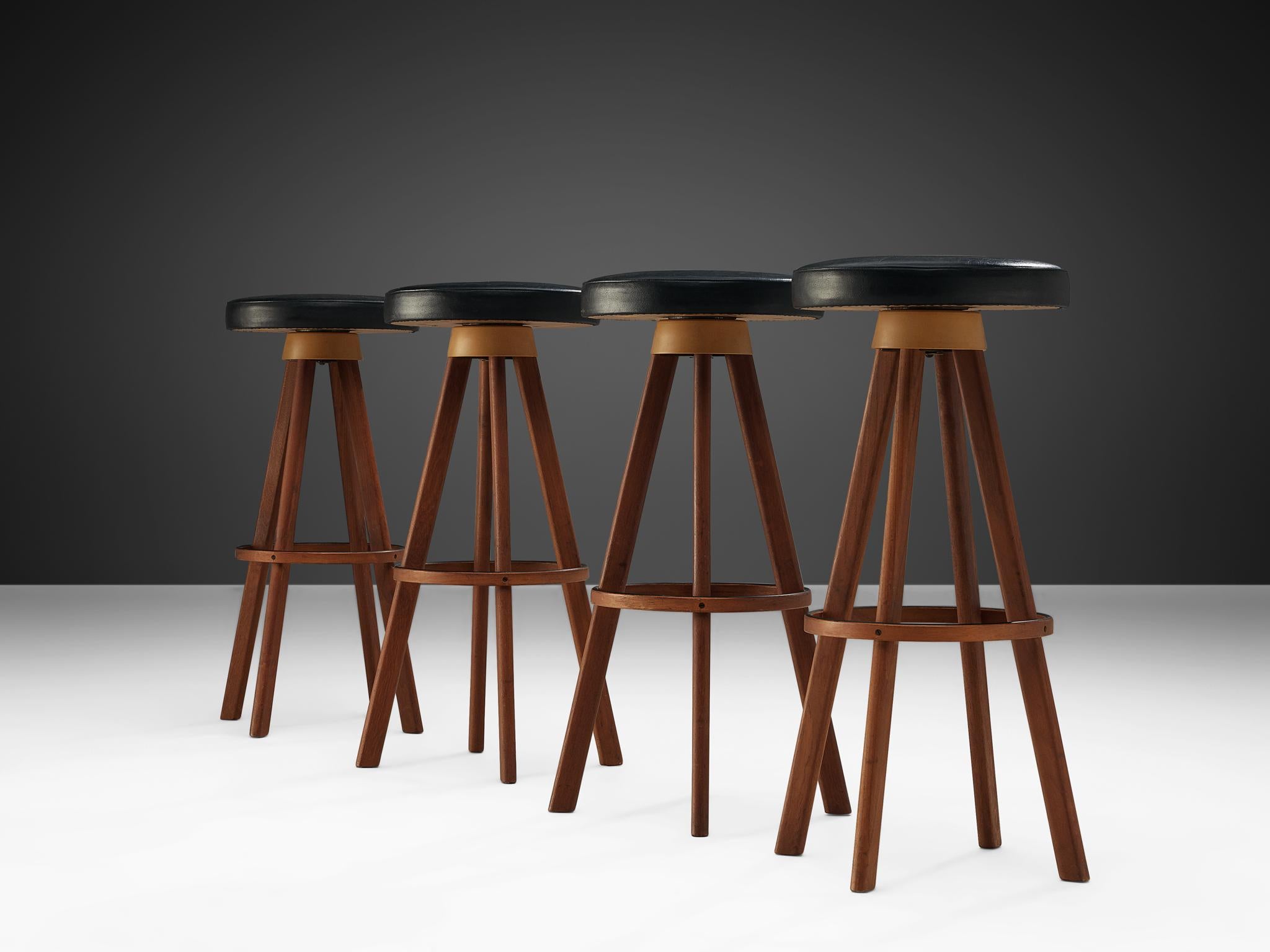 Bar stools manufactured by Frem Røjle, teak and faux leather, Denmark, 1960s.

These bar stools are very solid and modest in their appearance. The frame of the stools, including the ring that connects the four legs is executed in teak. The round