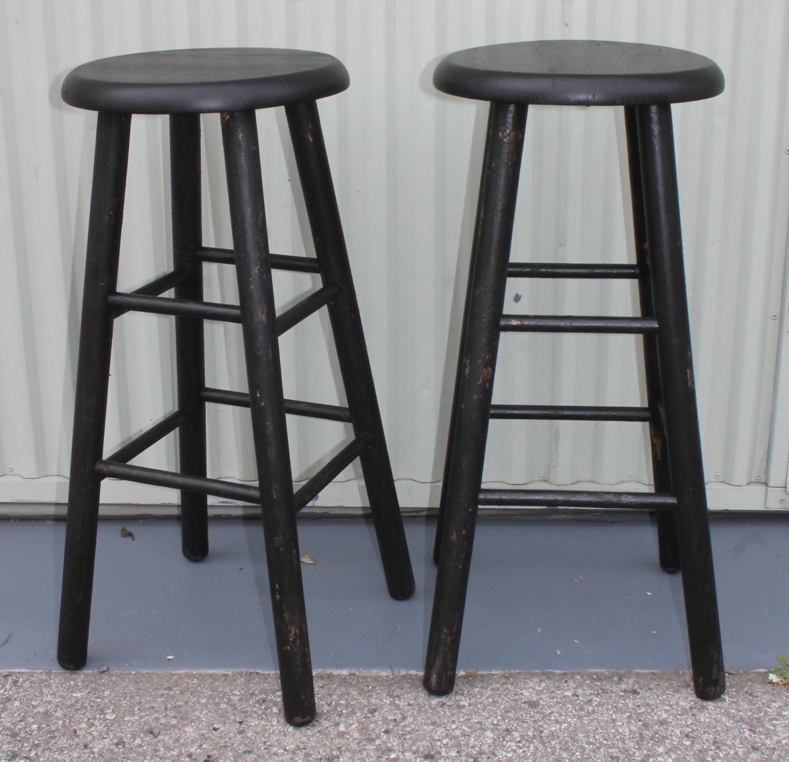 Pair of midcentury plank seat bar stools. Beautiful black painted surface. In great and sturdy condition.