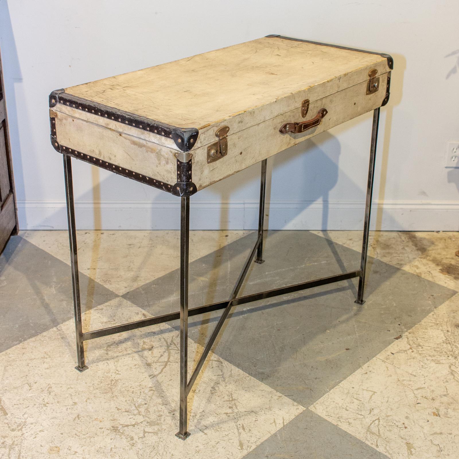 We sourced this very charming antique French luggage piece, well-traveled as evidenced by the wear, and imagined it as a bar table. The custom, handcrafted base is attached to the bottom of the case, allowing the interior to be used for storage. The