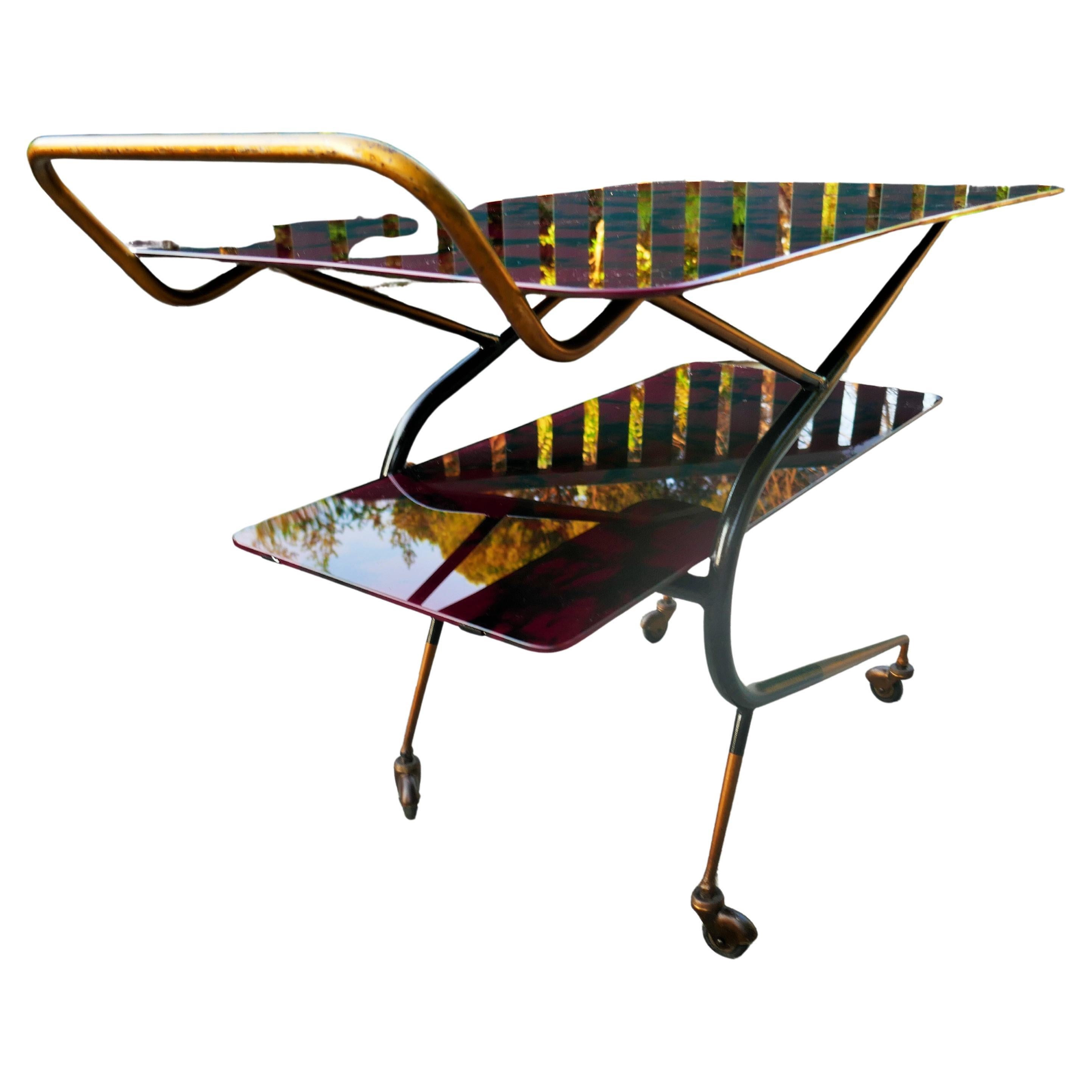 Bar trolley in the style of Ico Parisi or Cesare Lacca.
The two tops are made of glass and a film has been applied on velvet that makes the top marbled.
Small defects but in good condition.
Thanks